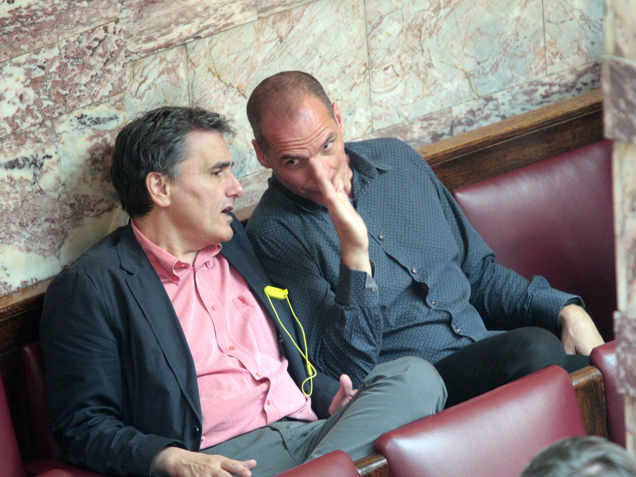 The Greek Finance Minister, Euclid Tsakalotos, left, and his predecessor, Yanis Varoufakis, talking during a plenary session of the Greek parliament