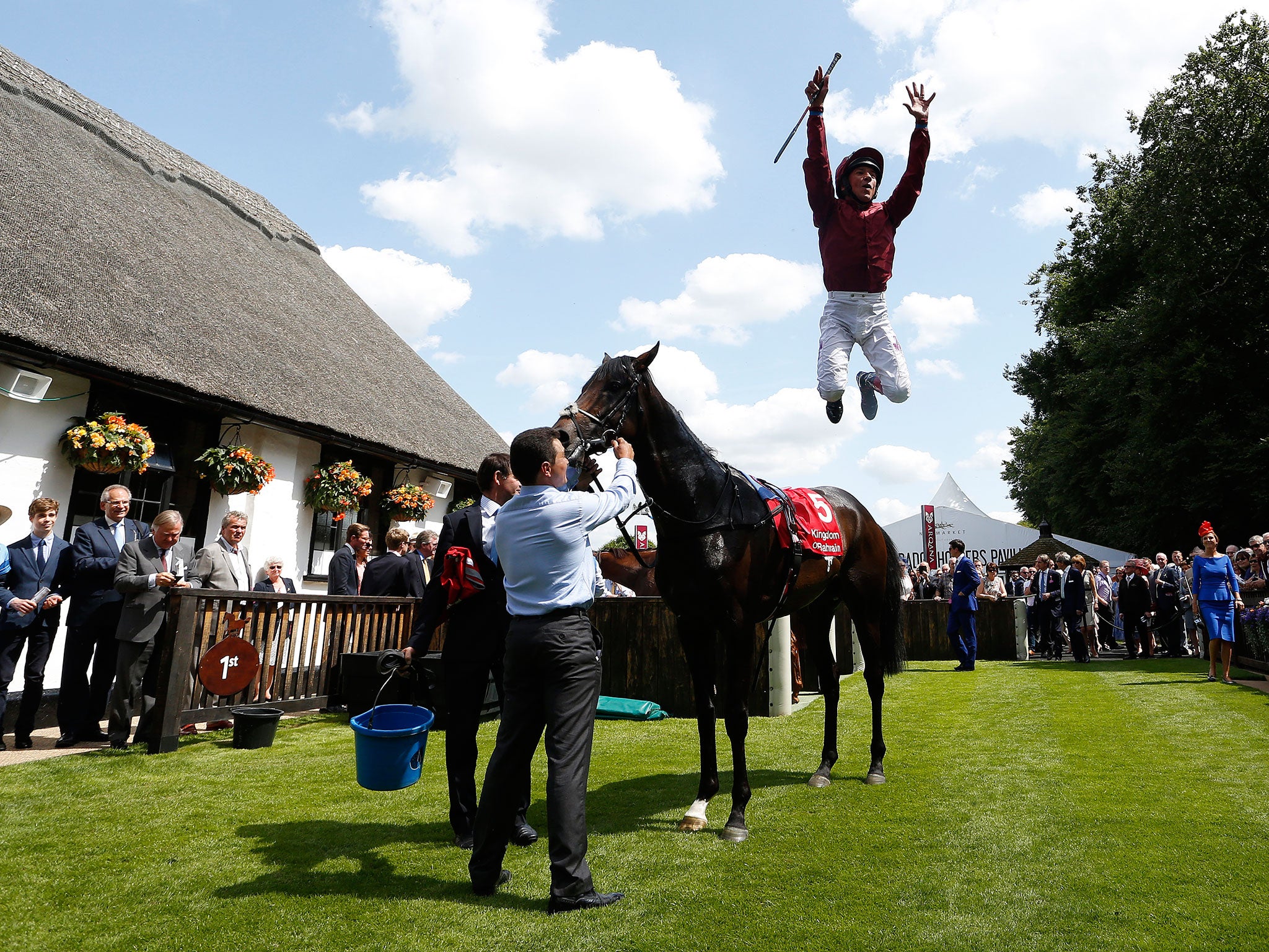 Frankie Dettori performs his flying dismount after winning the opener at Newmarket’s July Course on Mr Singh