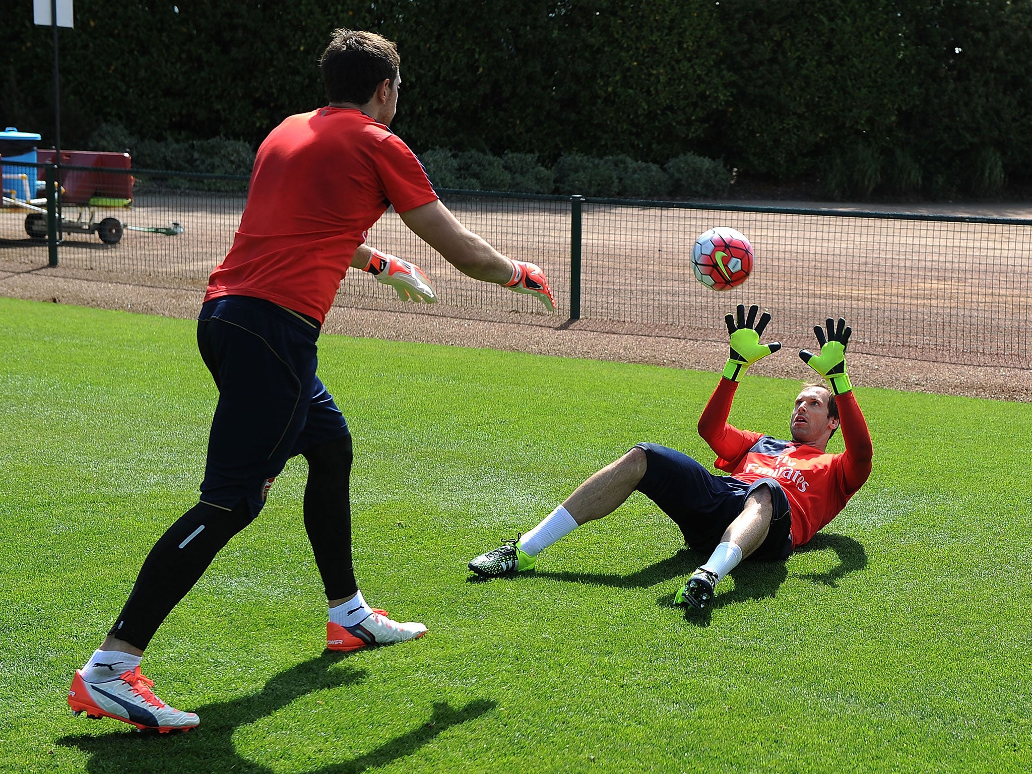 Petr Cech performs a drill with fellow stopper Emiliano Martinez