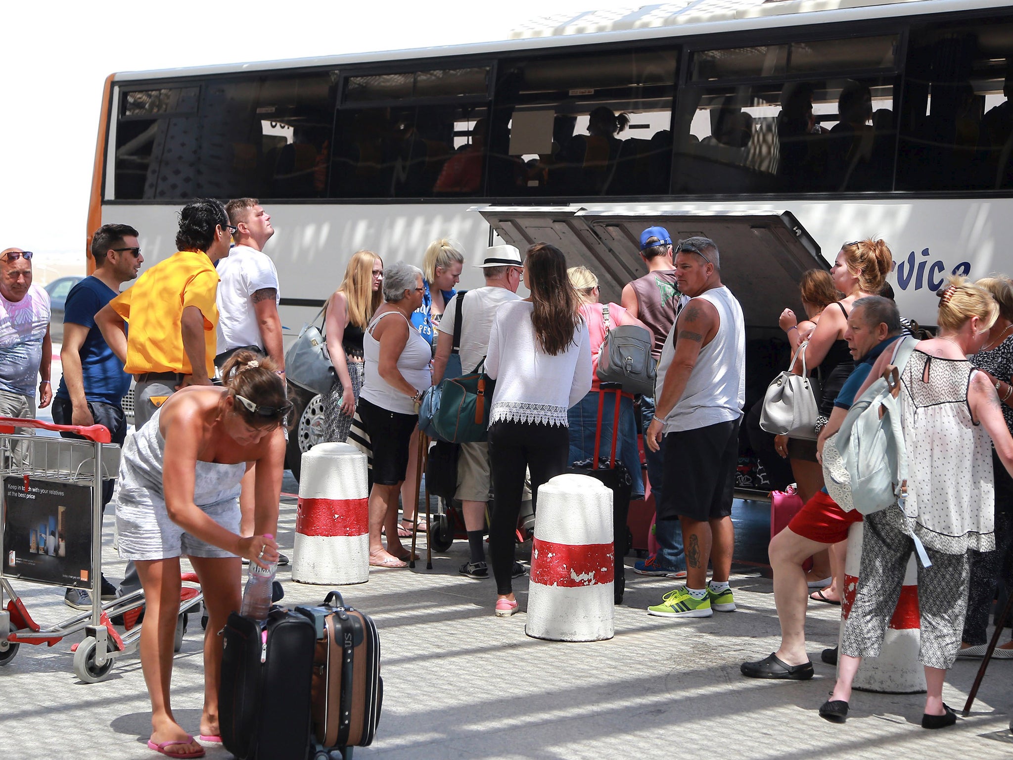 Tourists arrive at the Enfidha international airport, as they wait to leave Tunisia