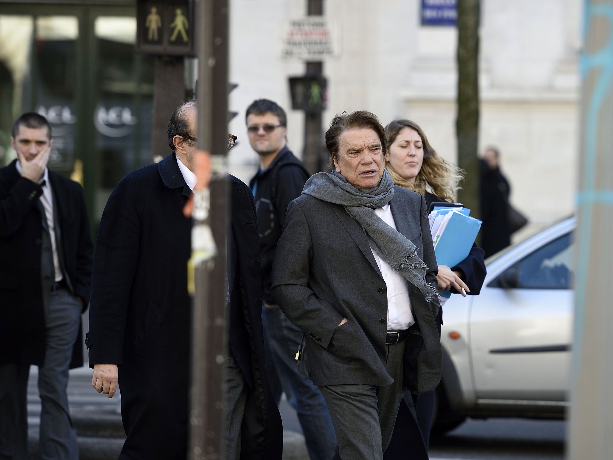 French businessman Bernard Tapie (foreground) arrives for a hearing at the financial pole on March 12, 2015