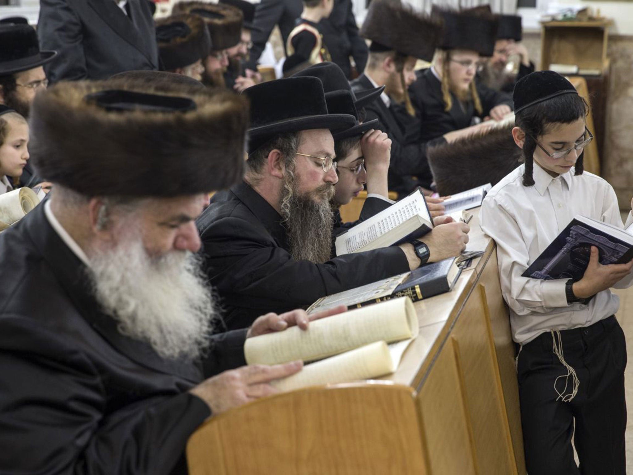 Ultra-Orthodox Jews read the Esther scrolls at a synagogue in the Israeli Mediterranean coastal city of Netanya