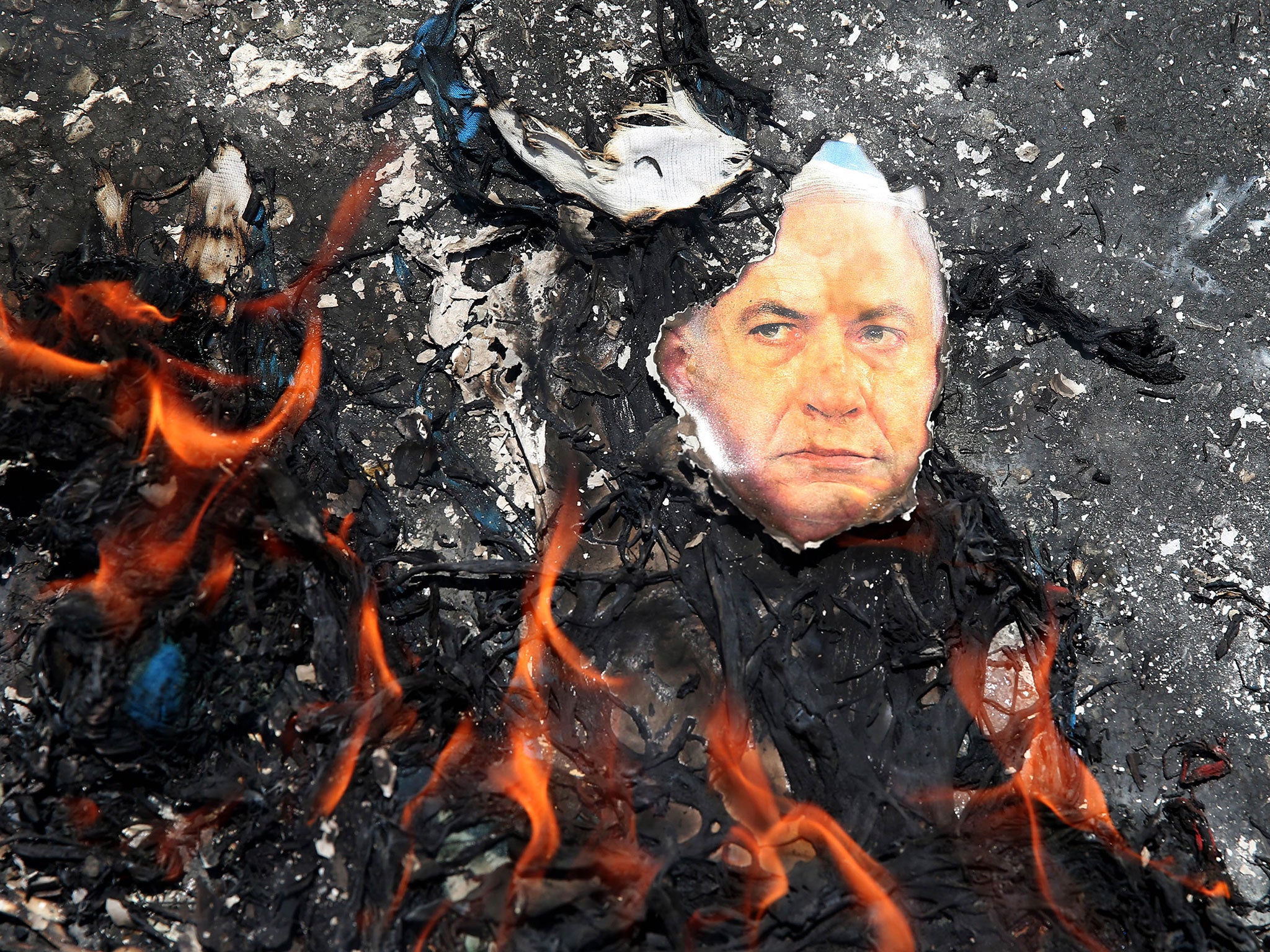 A portrait of the Israeli Prime Minister Benyamin Netanyahu is set on fire during an annual pro-Palestinian rally marking Al-Quds (Jerusalem) Day