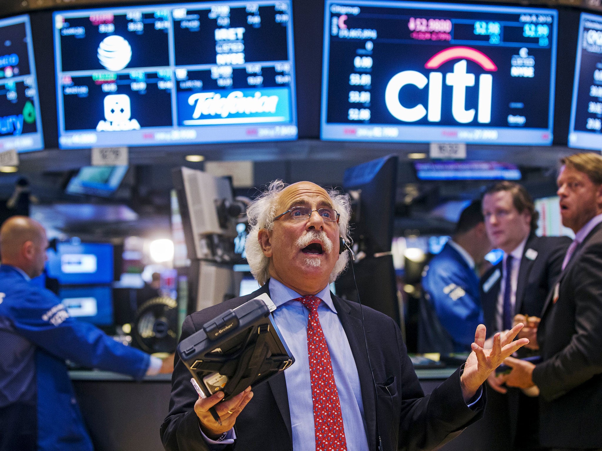 Let there be light: a trader at the resumption of business on the floor of the New York Stock Exchange on Wednesday