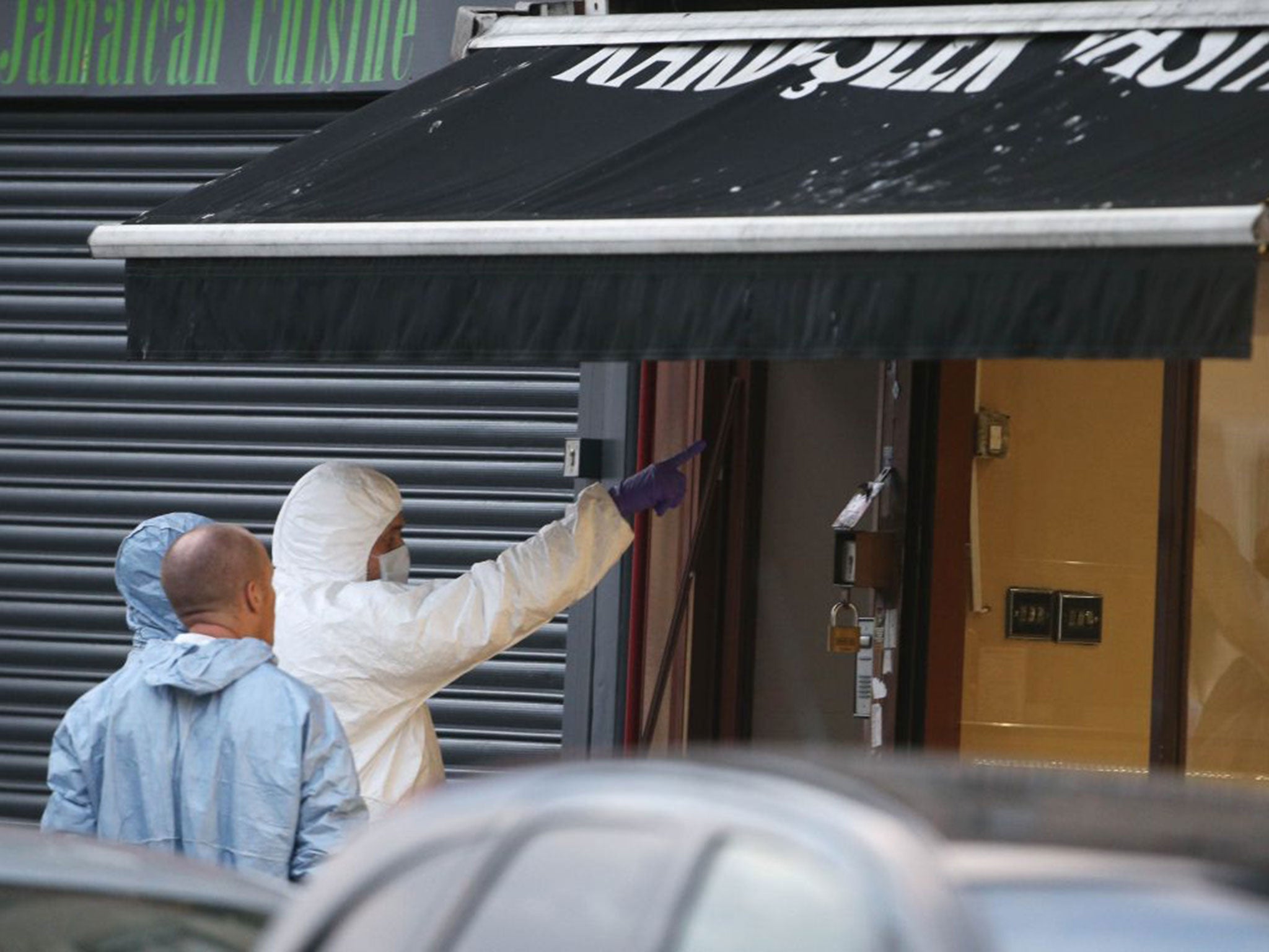 People in forensic suits as emergency services attend the scene in Lordship Lane, Wood Green, north London