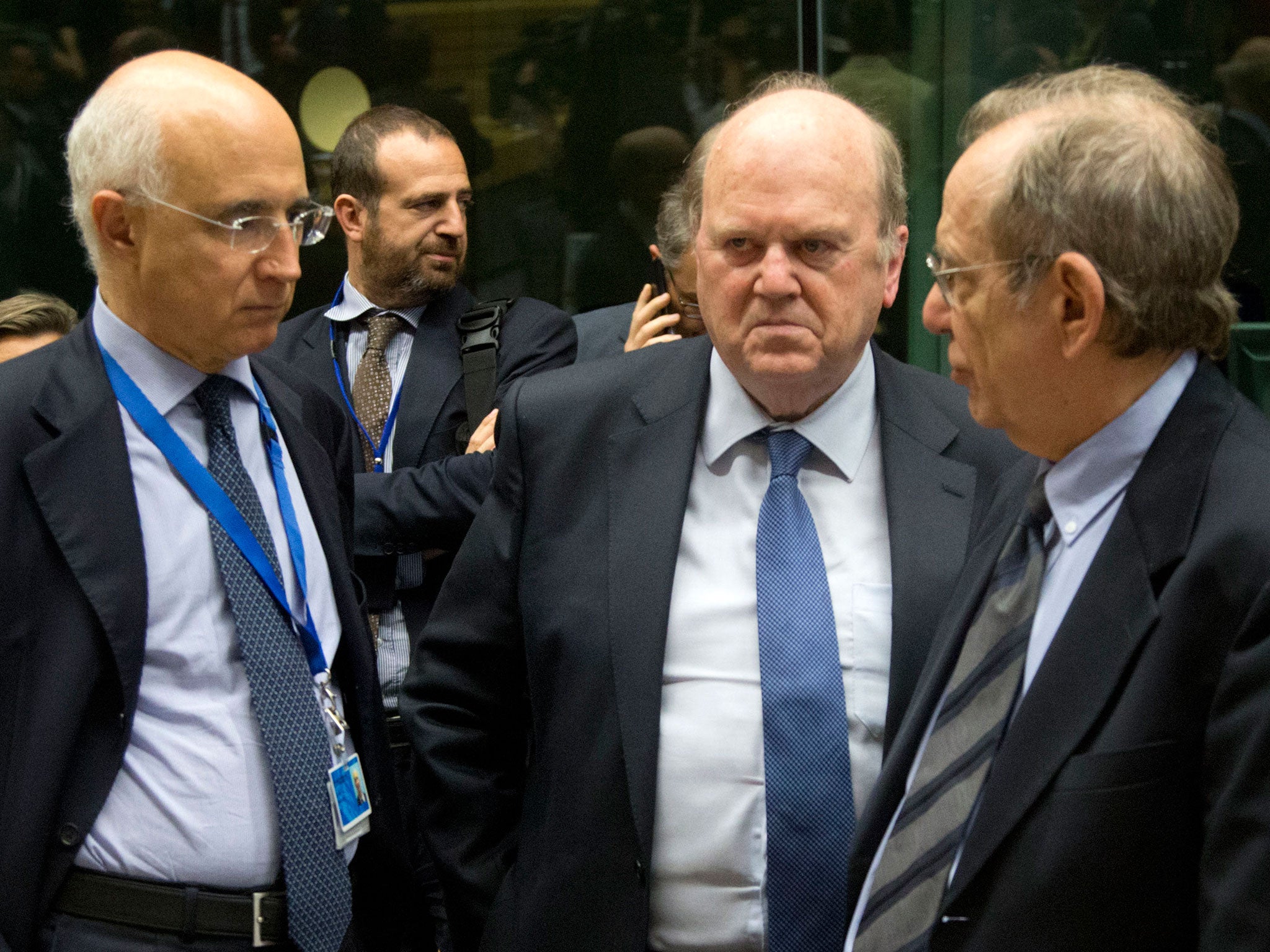 Irish Finance Minister Michael Noonan, center, speaks with Italian Finance Minister Pier Carlo Padoan