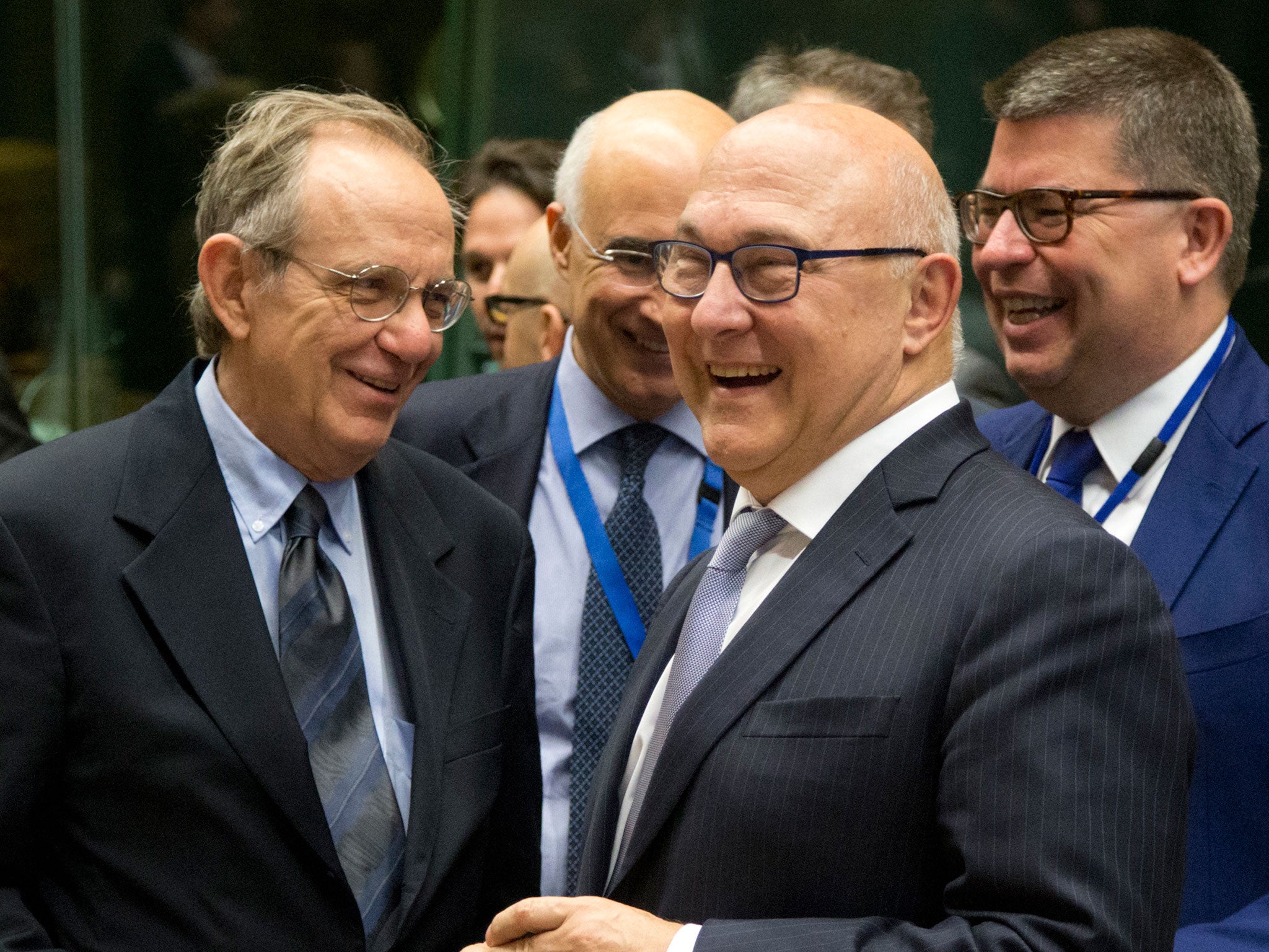 French Finance Minister Michel Sapin, second right, speaks with Italian Finance Minister Pier Carlo Padoan, left