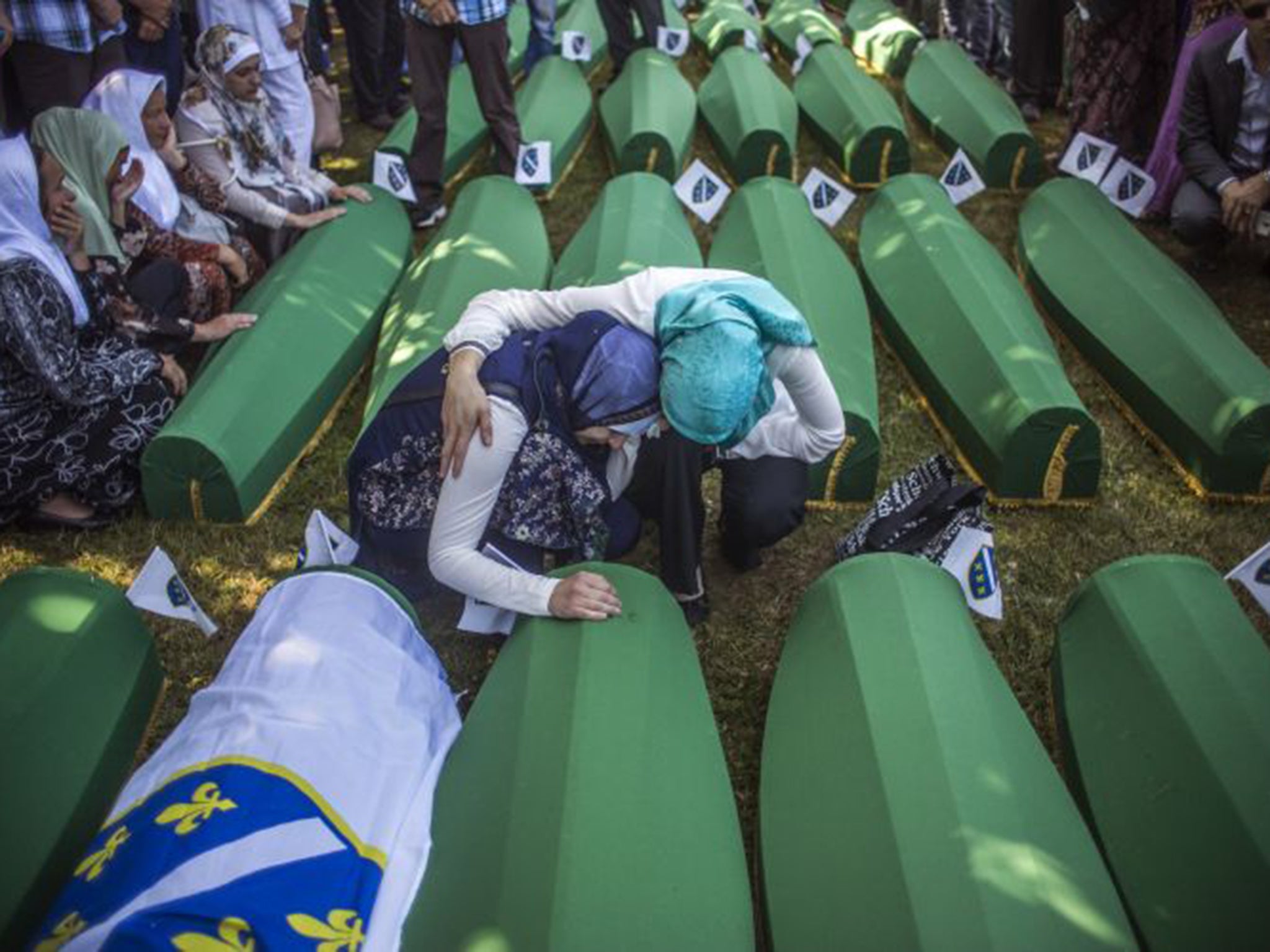 Women at the burial on Saturday of victims of the 1995 massacre