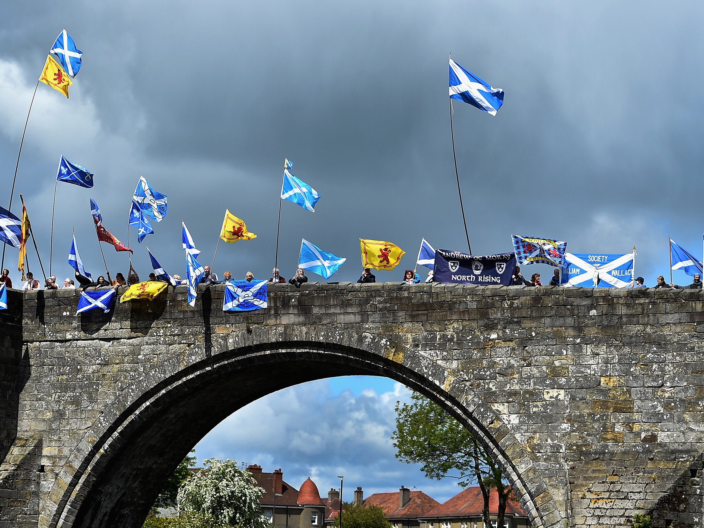 Stirling residents stood on a bridge waving flags