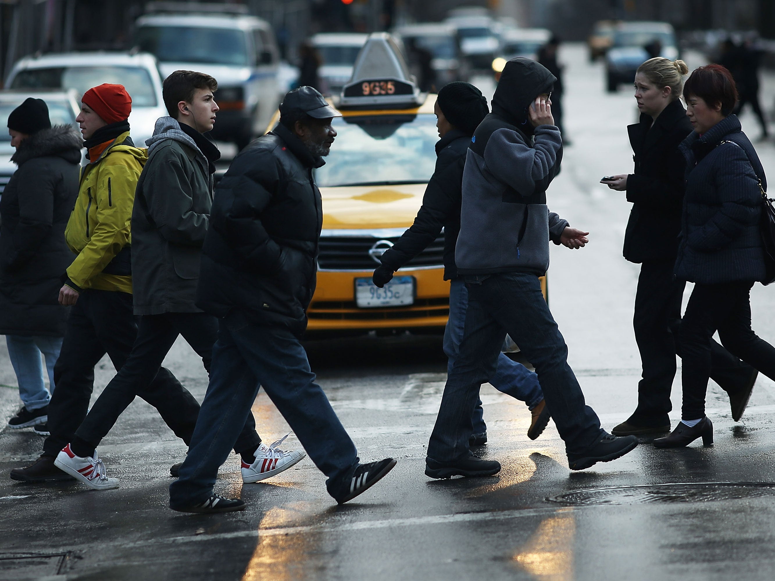 Pedestrians cross a street on Broadway, New York City