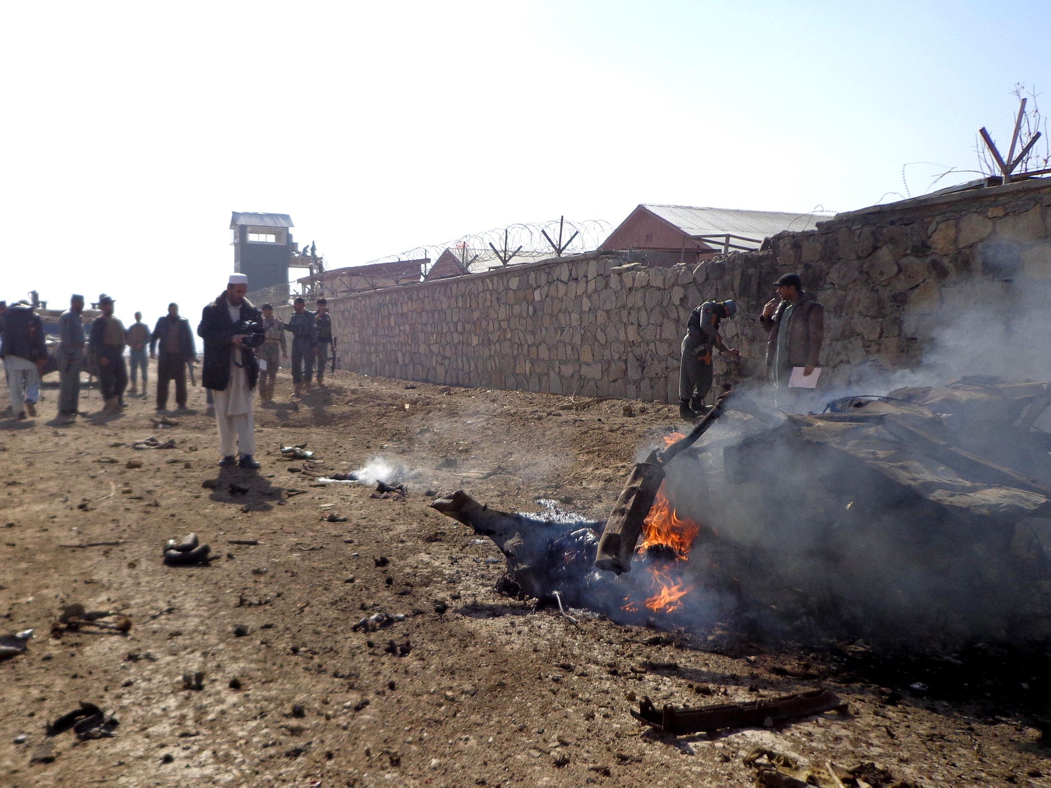 (FILE PHOTO, JANUARY 2015) Afghan security forces inspect the site of an attack by Taliban militants in the Khost province in eastern Afghanistan