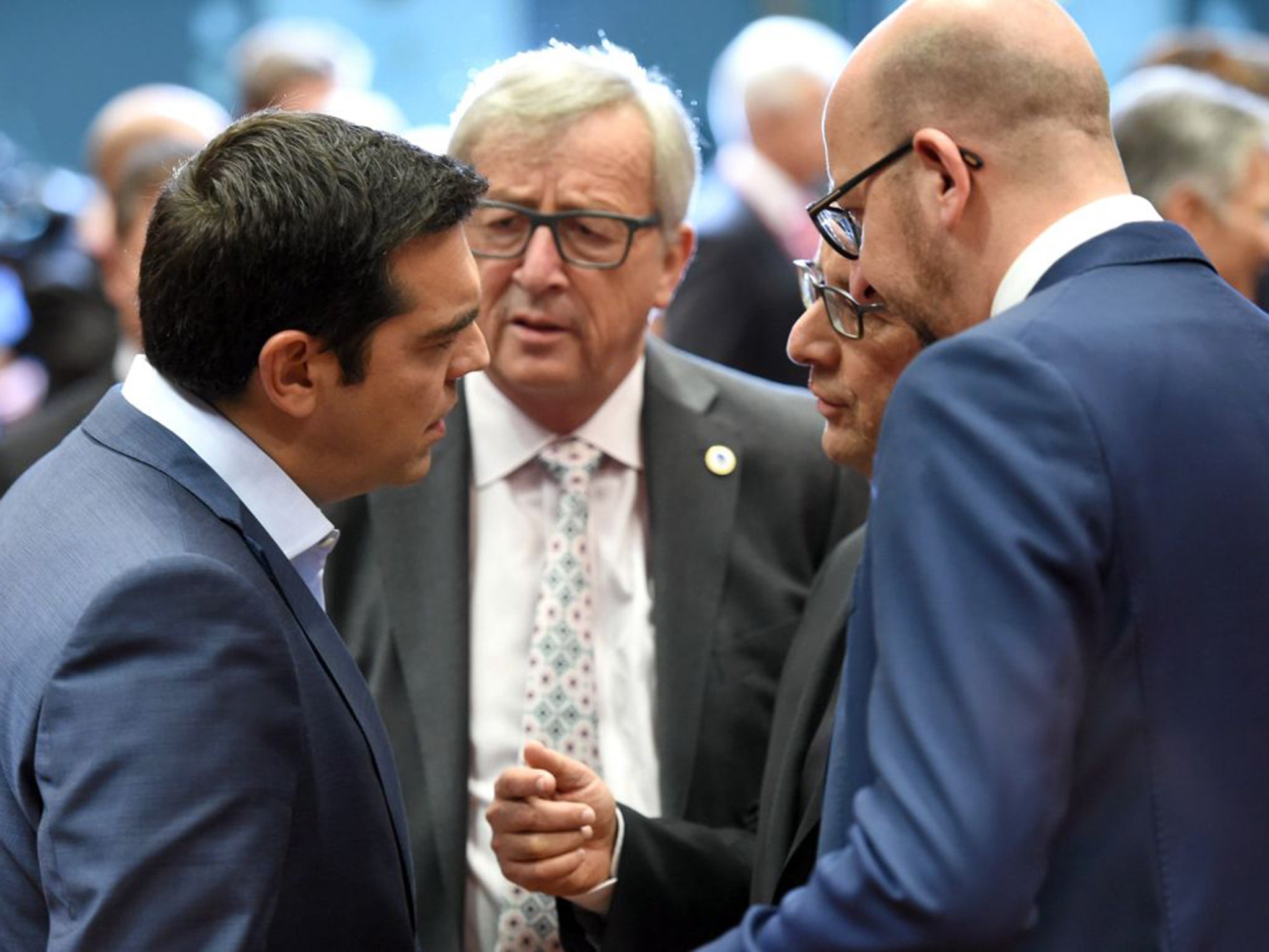 Greek Prime Minister Alexis Tsipras, left, speaks with, from left, European Commission President Jean-Claude Juncker, French President Francois Hollande and Belgian Prime Minister Charles Michel during a meeting of eurozone heads of state at the EU Counci