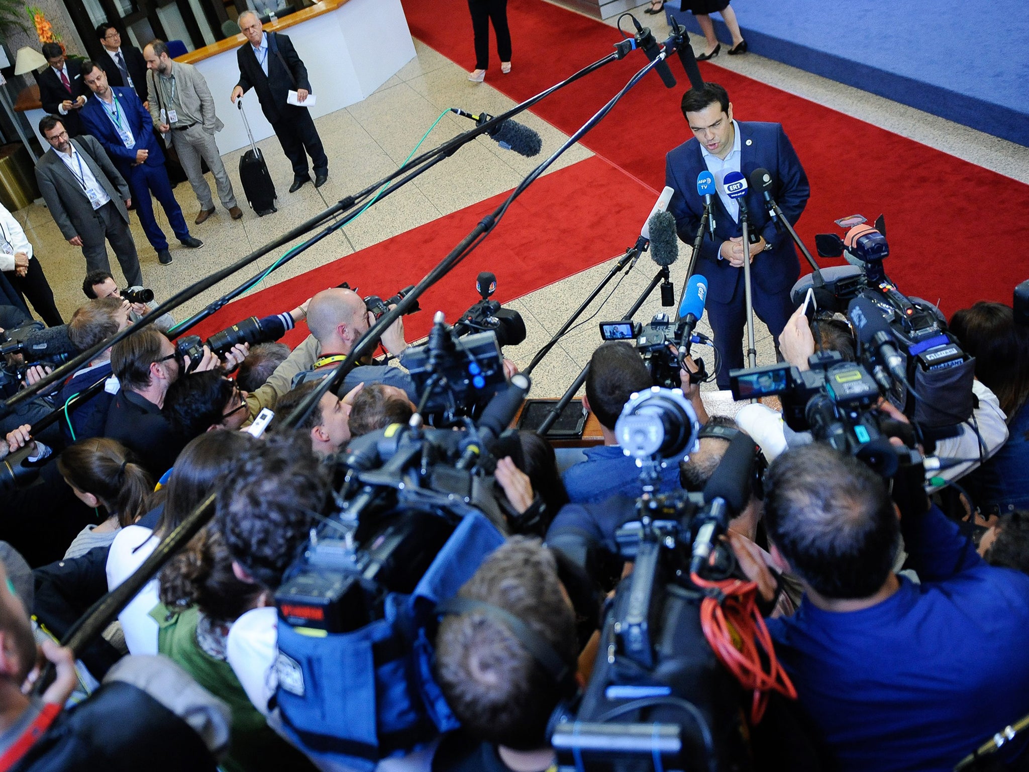 Alexis Tsipras talks to the press at the end of the marathon 17-hour Eurozone leader summit