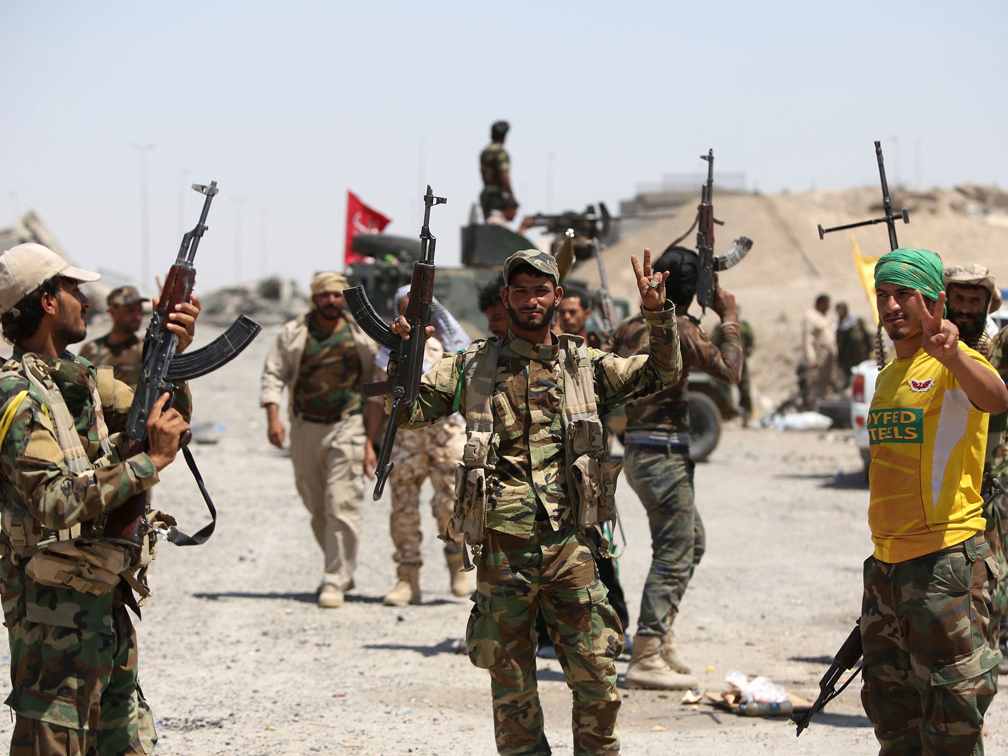 Shia fighters from Hashid Shaabi units supporting Iraqi government forces gather on the outskirts of Fallujah, west of Baghdad, to prepare an attack on Isis positions in the city