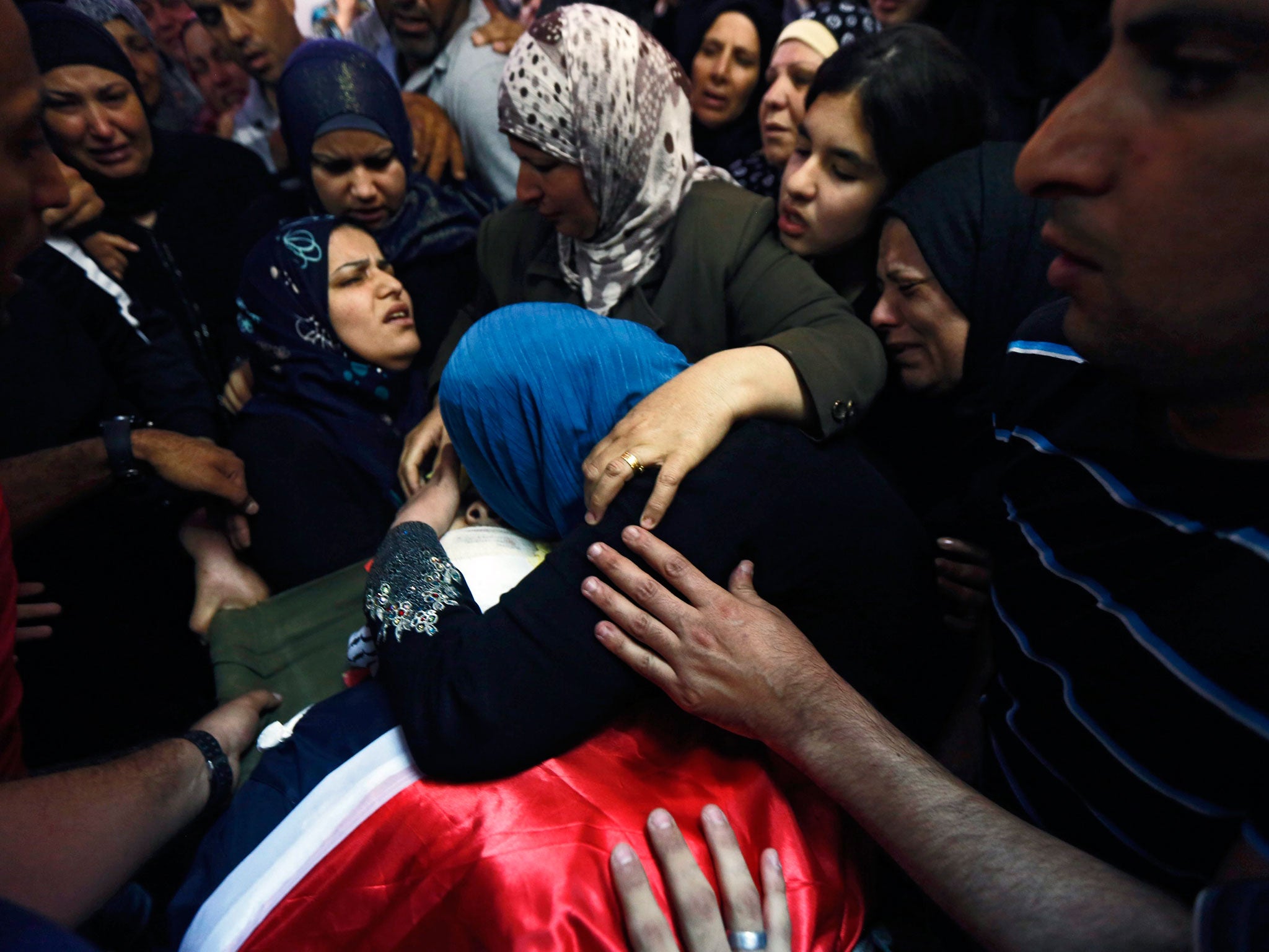 Mohammed Ali-Kosba’s mother weeps at his funeral