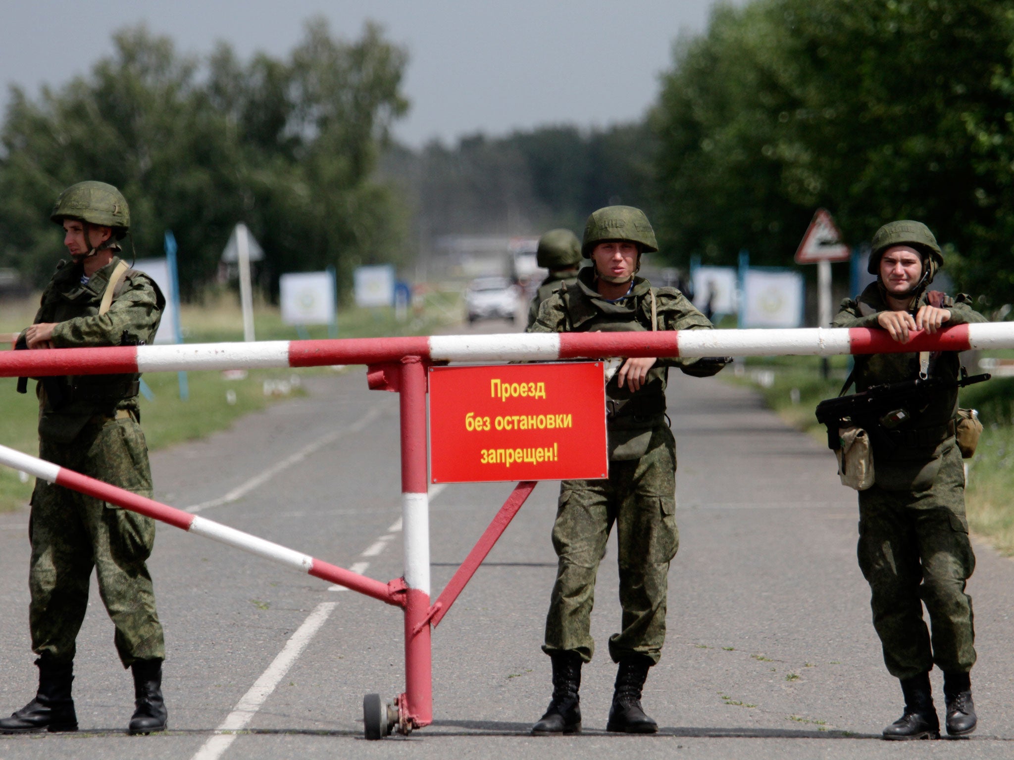 Soldiers stand guard at the entrance to a military base in Omsk, Russia where the ceiling collapsed, causing four stories to crumble