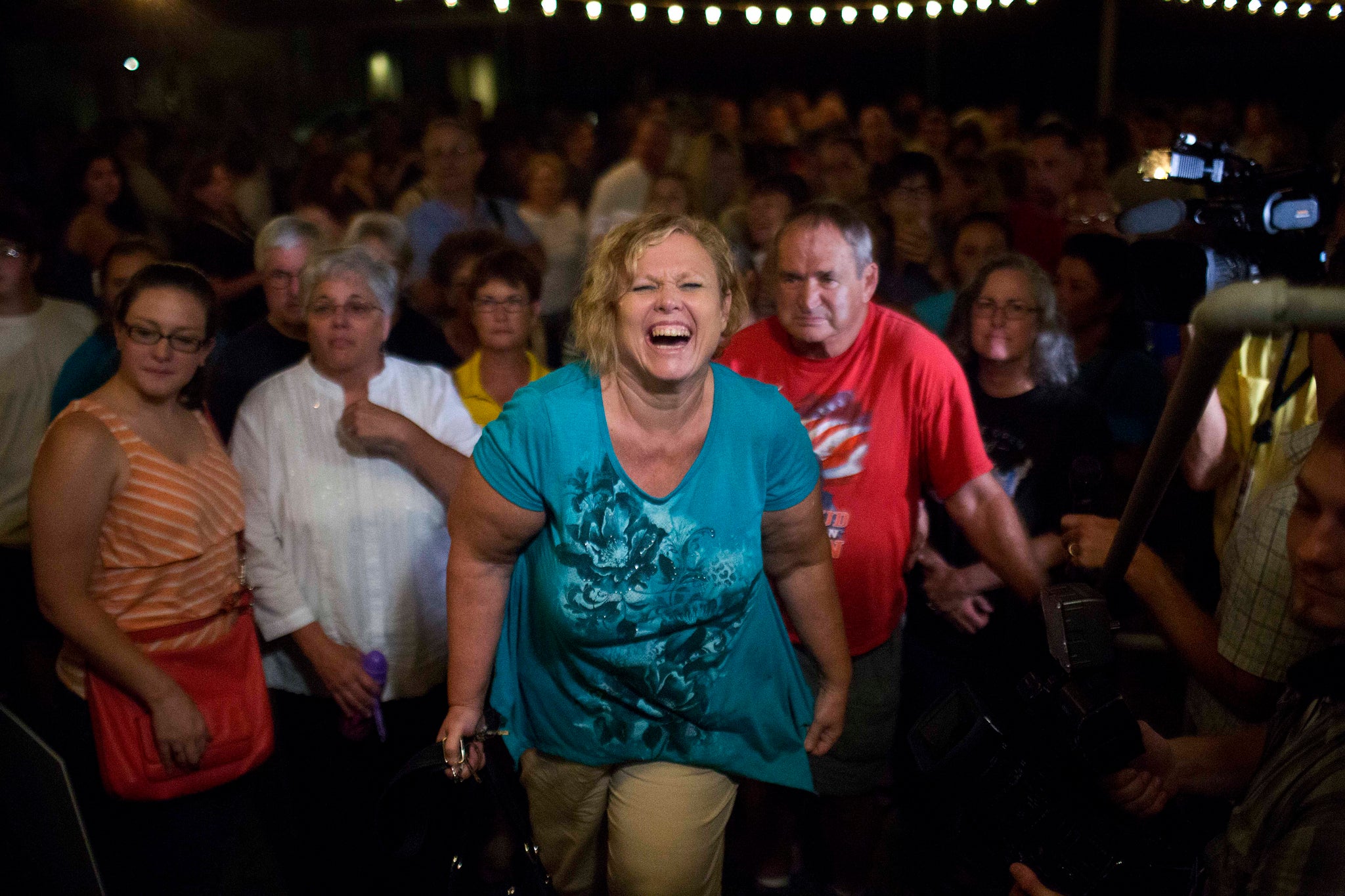 Judy May, of Monroeville, Alabama, laughs walking up the stairs as the second person to receive a copy of Go Set a Watchman in Harper Lee's hometown