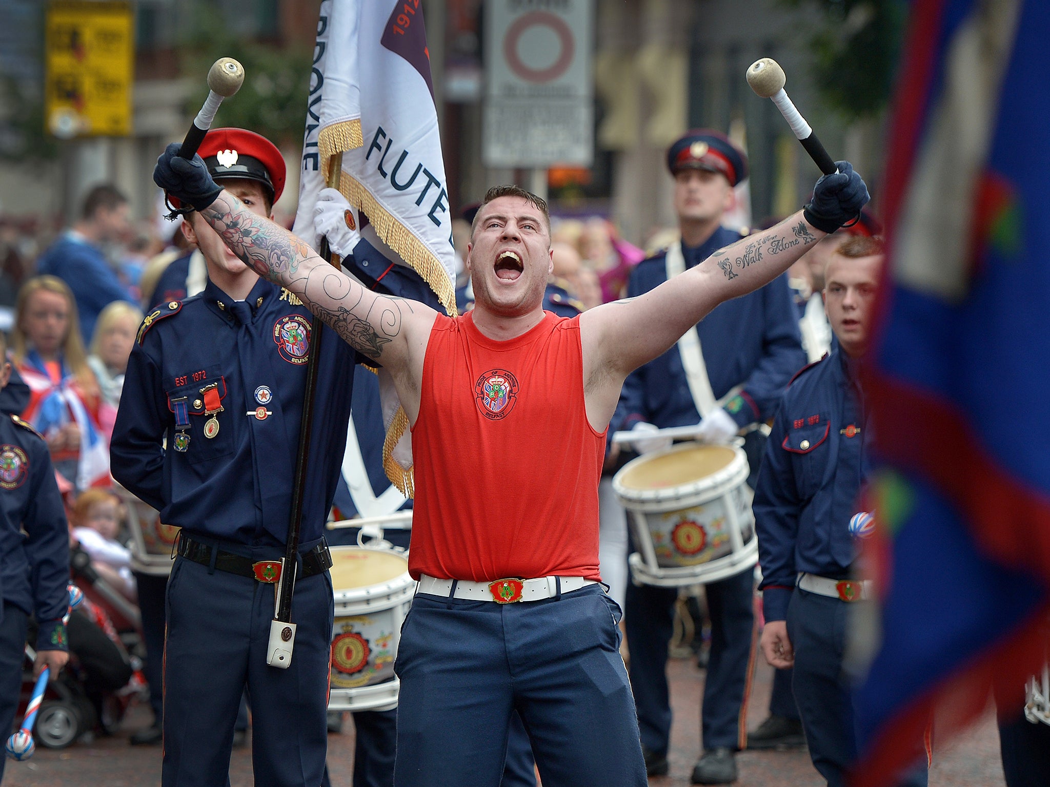 An Orange bandsman screams as he passes supporters and onlookers during the Twelfth of July parade in Belfast, Northern Ireland. The Twelfth is an Ulster Protestant celebration held annually. It celebrates the victory of Protestant king William of Orange over Catholic king James II at the Battle of the Boyne in 1690