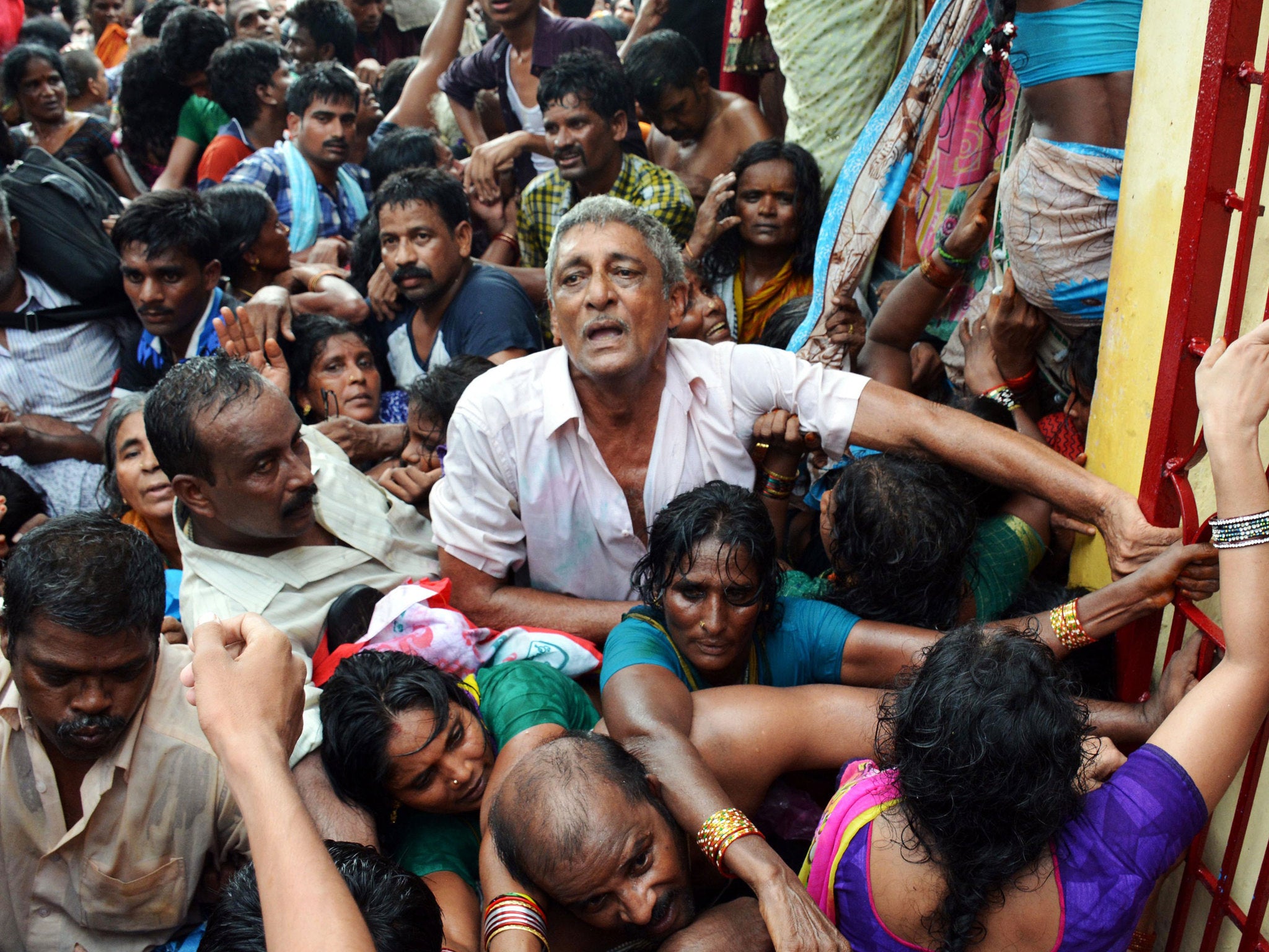 Indian devotees gather after a stampede at a religious festival in Godavar