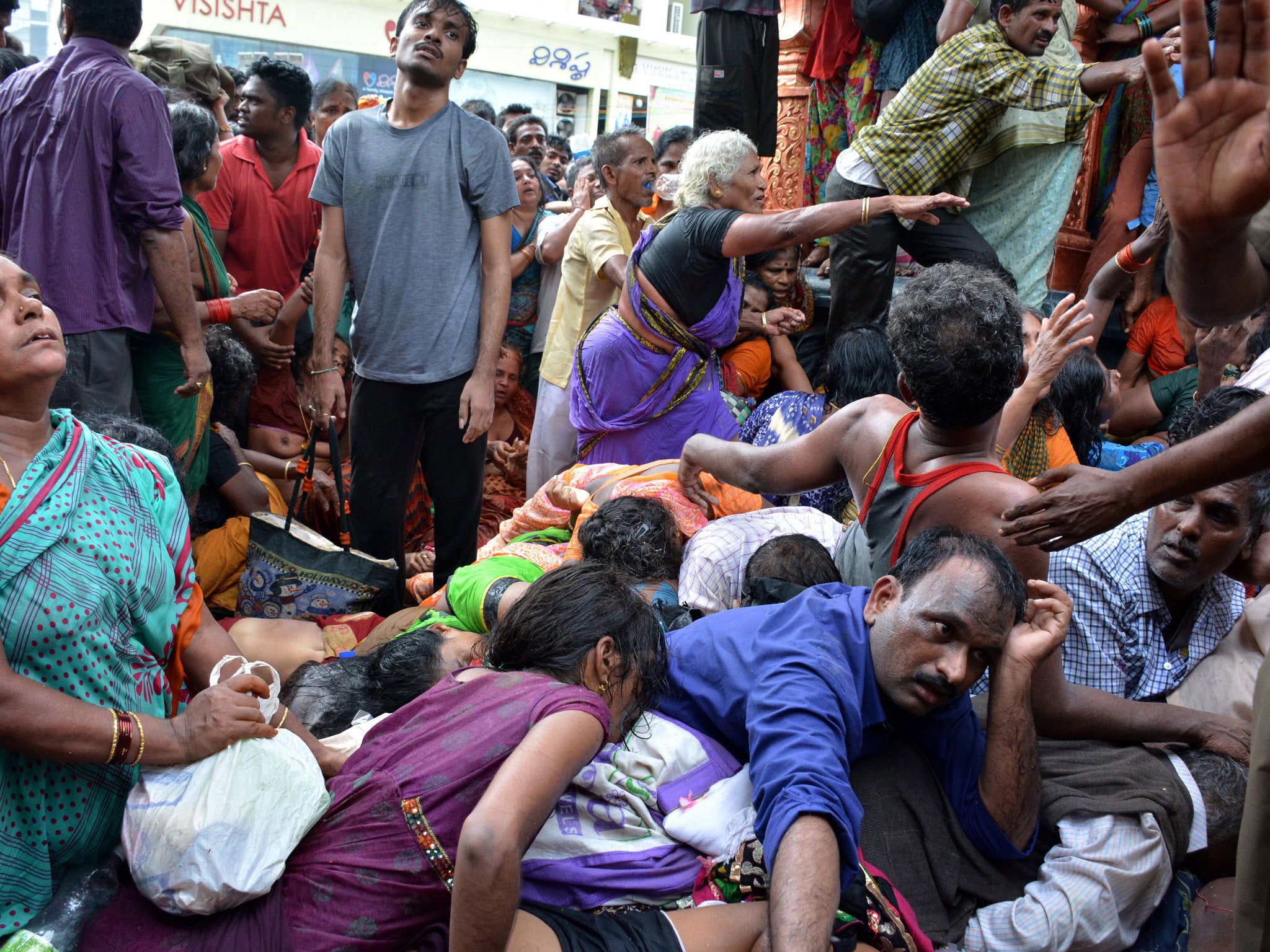 Indian pilgrims react after a stampede at a religious festival in Godavari