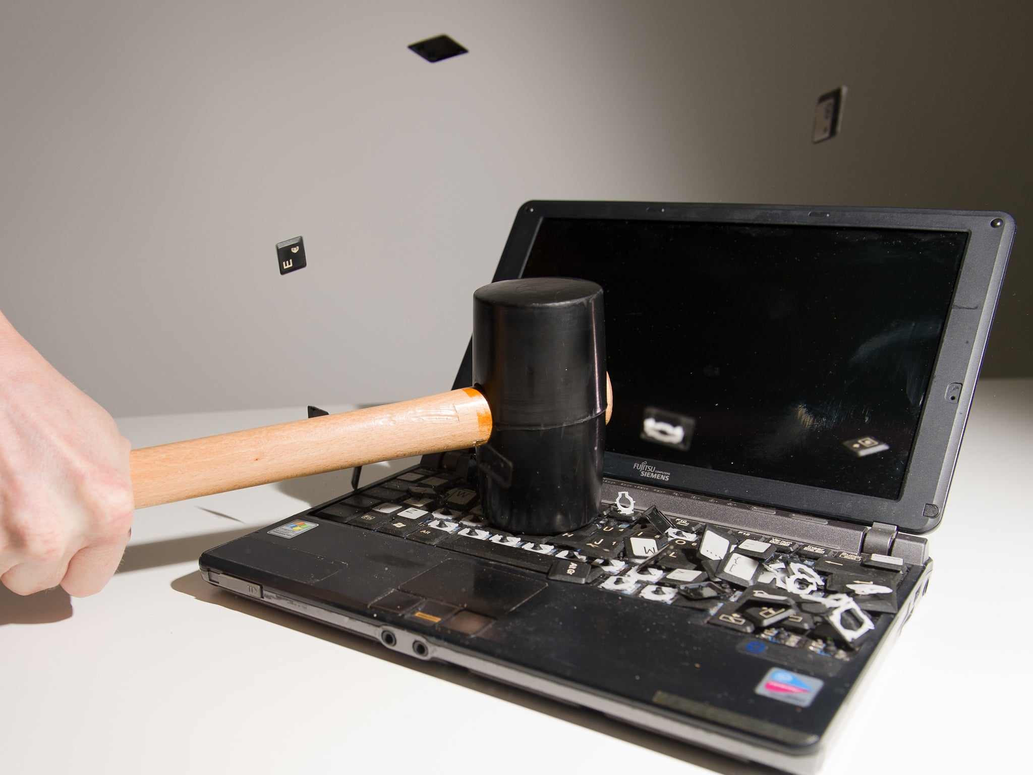 This picture taken in London on May 9, 2013 is a posed image of a laptop computer's keyboard shattering into pieces after an impact