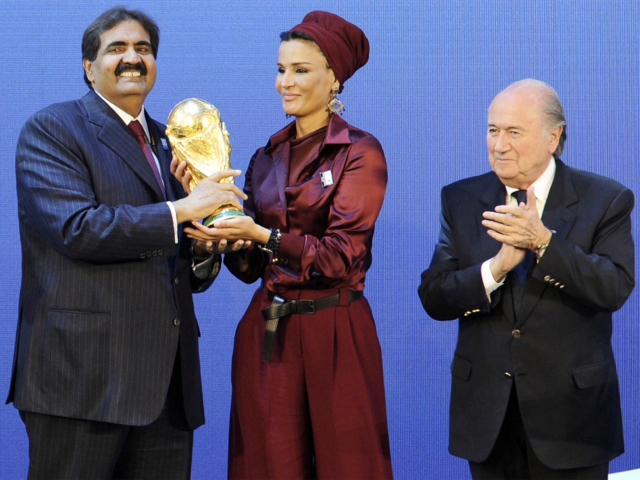 Emir of Qatar, Sheikh Hamad bin Khalifa Al-Thani, and his wife, Sheikha Mozah, with Sepp Blatter after being named host of the 2022 World Cup (Getty)