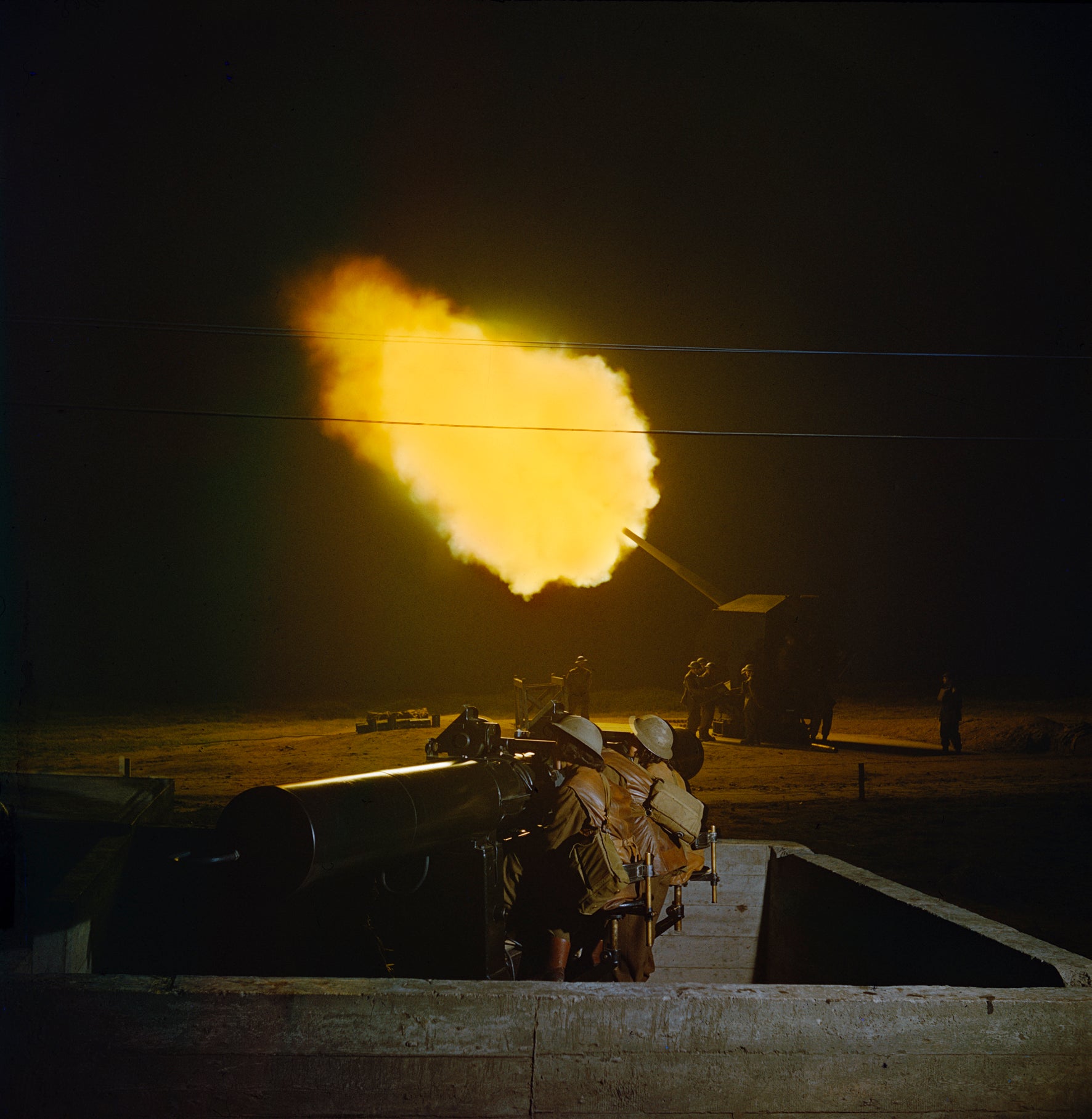 TR471: A battery of 3.7 inch anti-aircraft guns firing at night