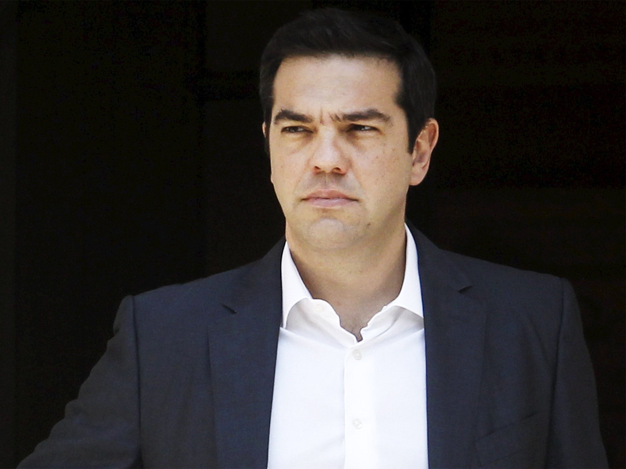 Greek Prime Minister Alexis Tsipras leaves his office at the Maximos Mansion in Athens on Wednesday