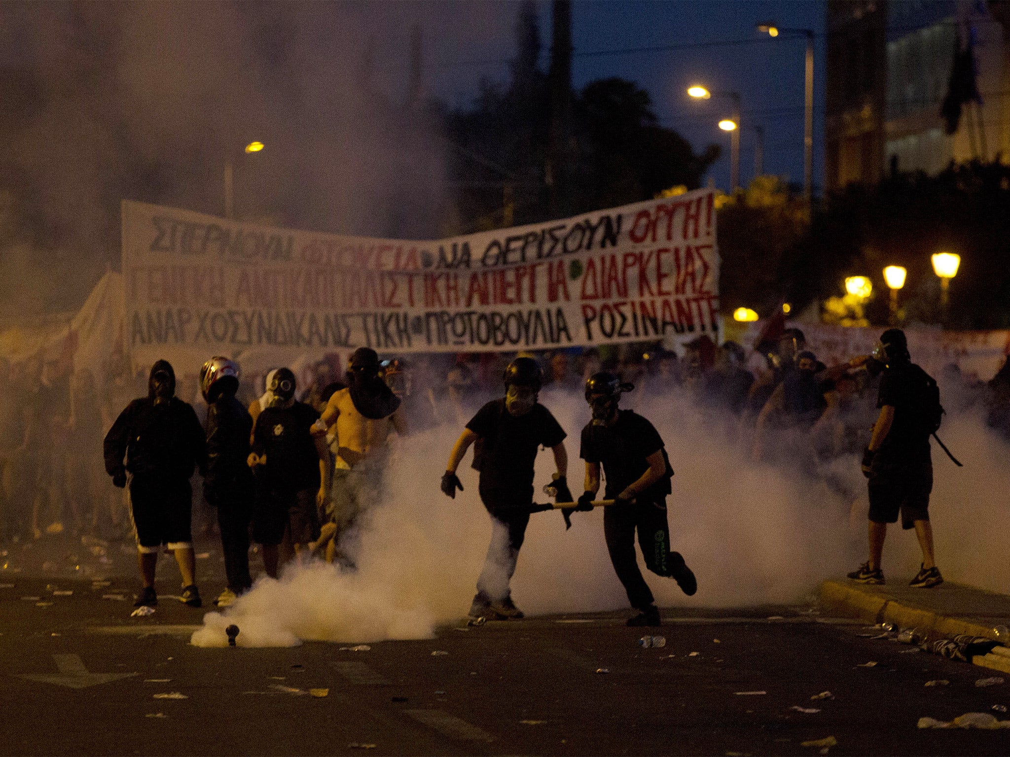 Anti-austerity protesters clash with riot police during a rally in Athens