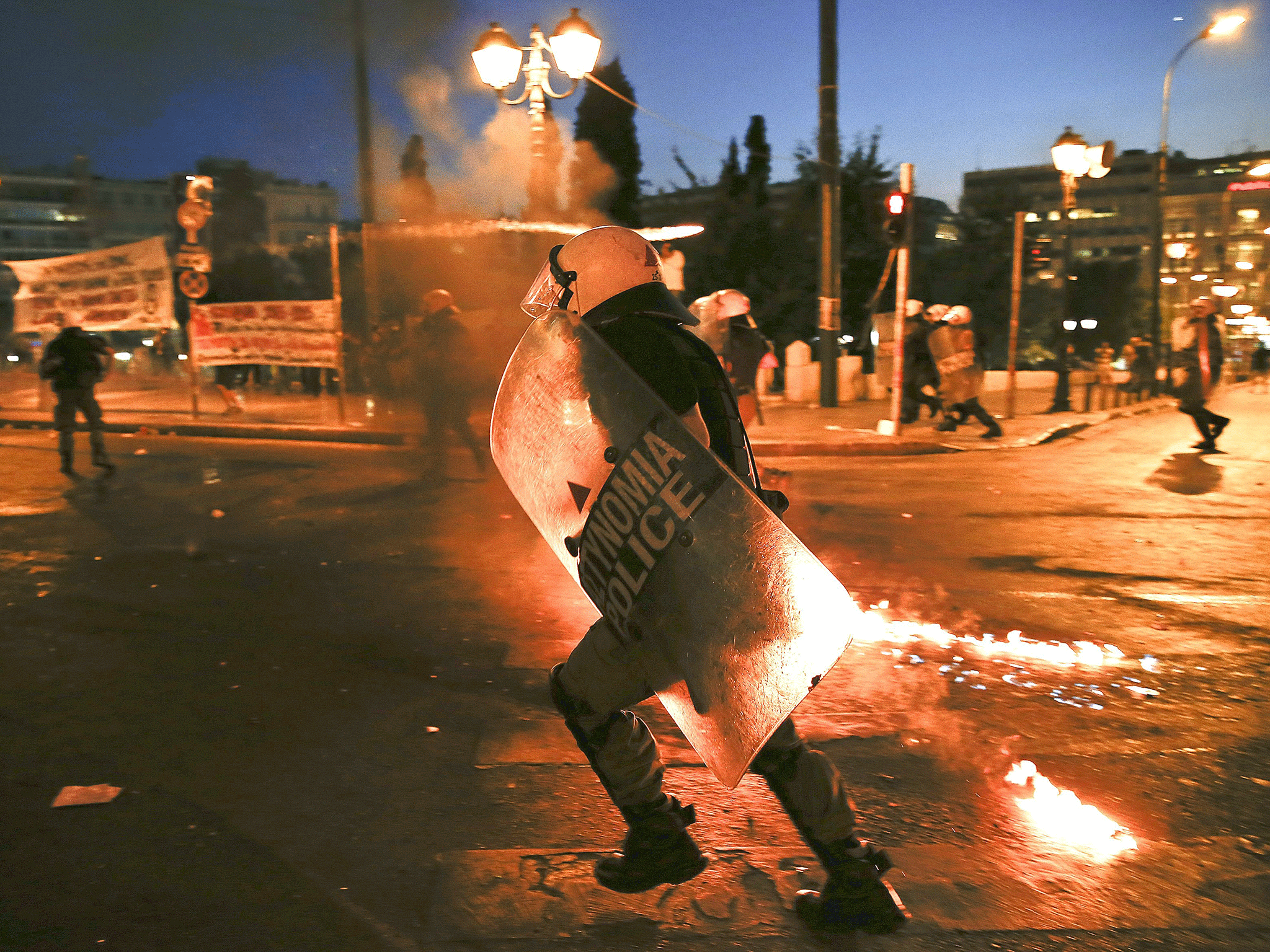 Riot police run as they disperse protesters during clashes in Athens on July 15 (Reuters)