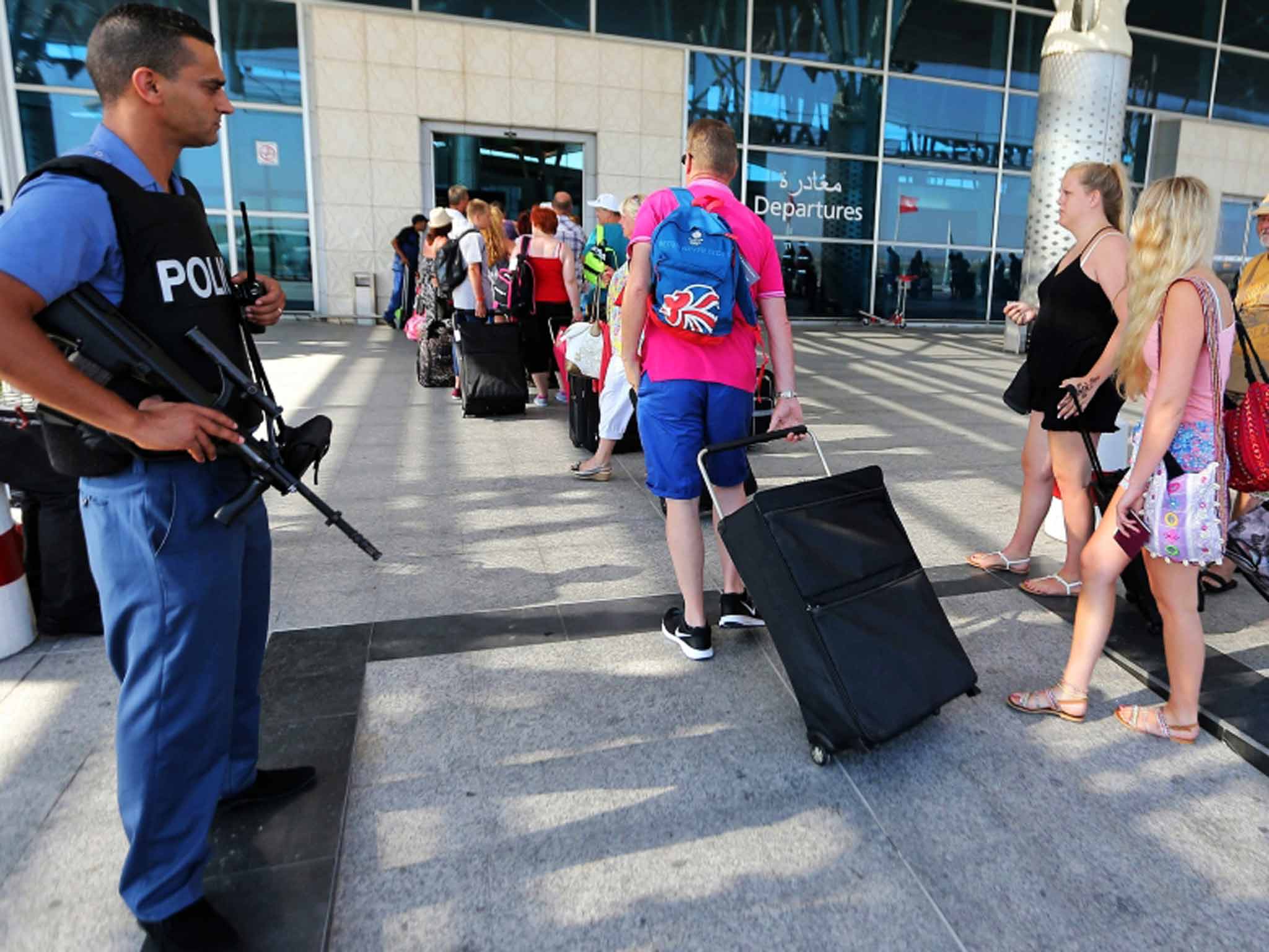 Armed farewell: British tourists leave Tunisia under heavy guard after the Sousse massacre