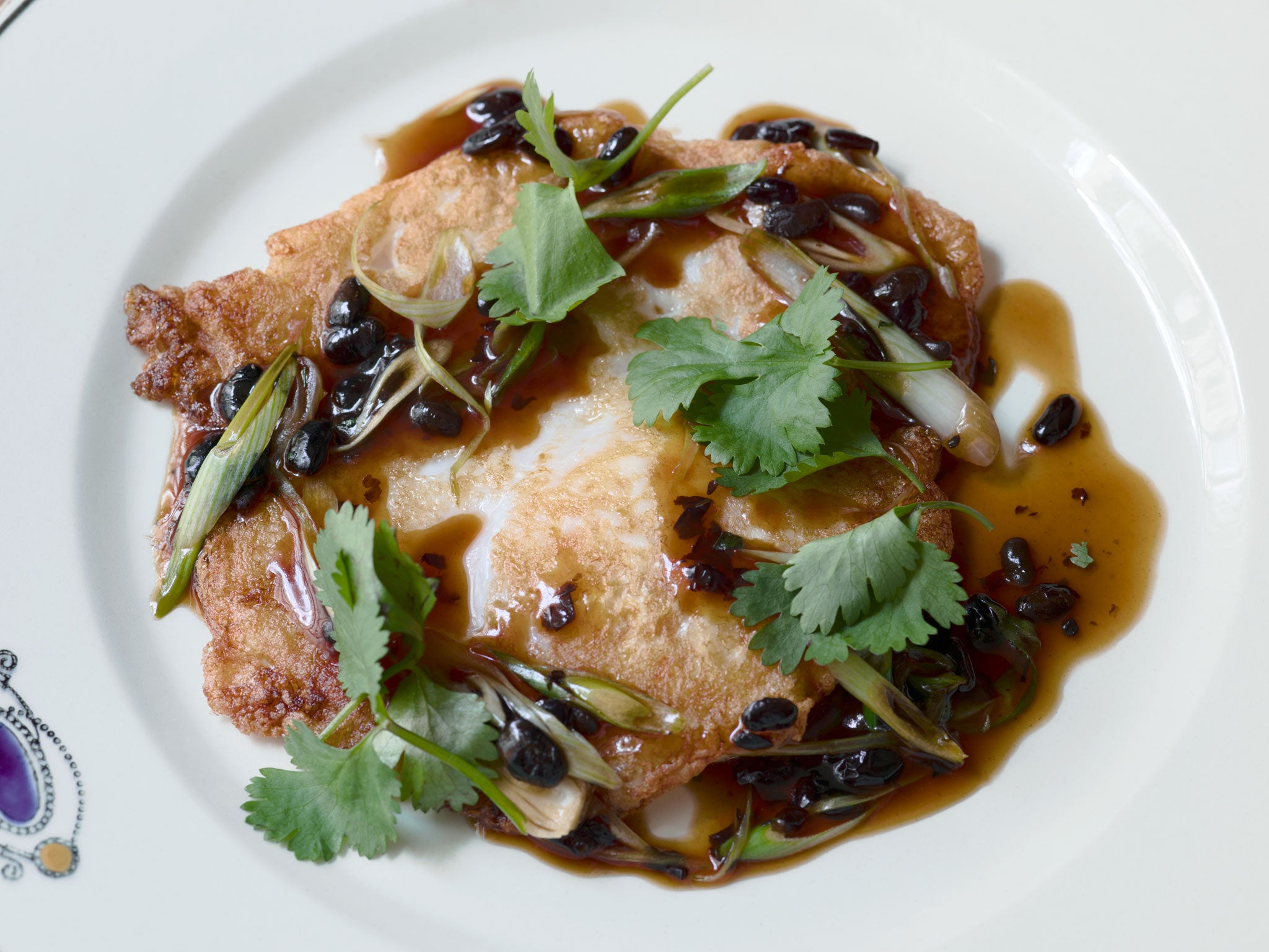 Crispy fried goose egg with black beans