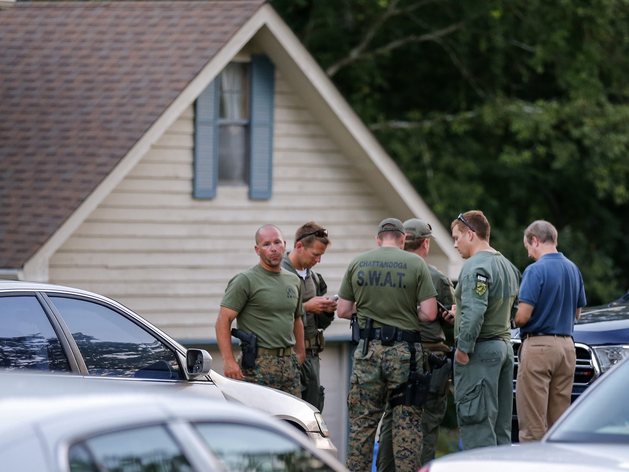 Law enforcement personnel gather outside the home of gunman Mohammod Youssuf Abdulazeez after a shooting in Chattanooga