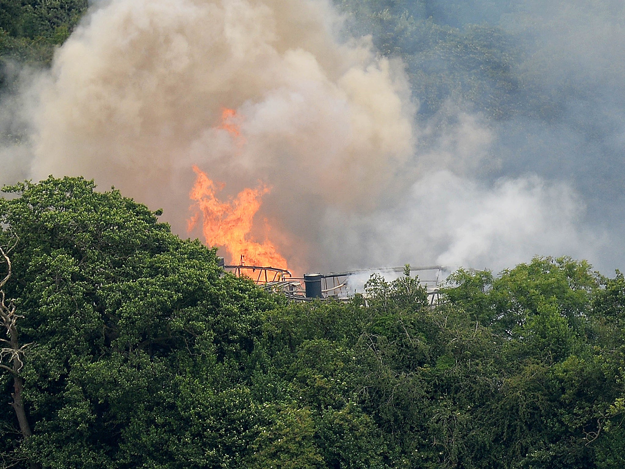 Flames are seen from Wood Flour Mills in Bosley, near Macclesfield, after an explosion and fire may have left four people trapped