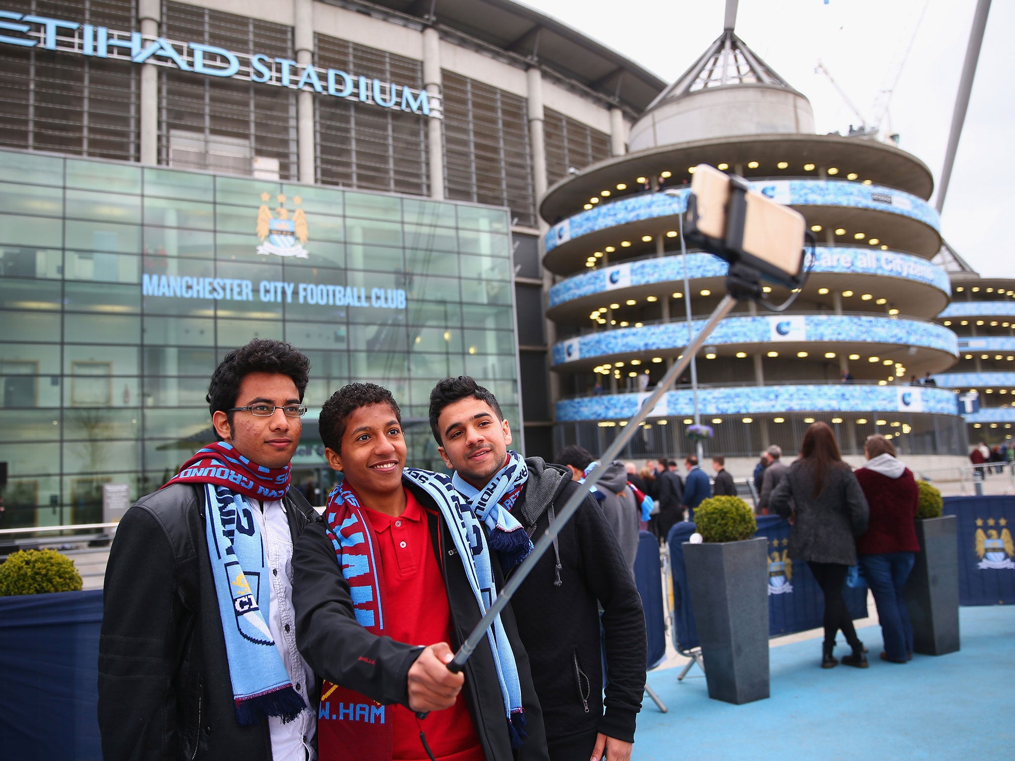 Fans outside Manchester City take a selfie