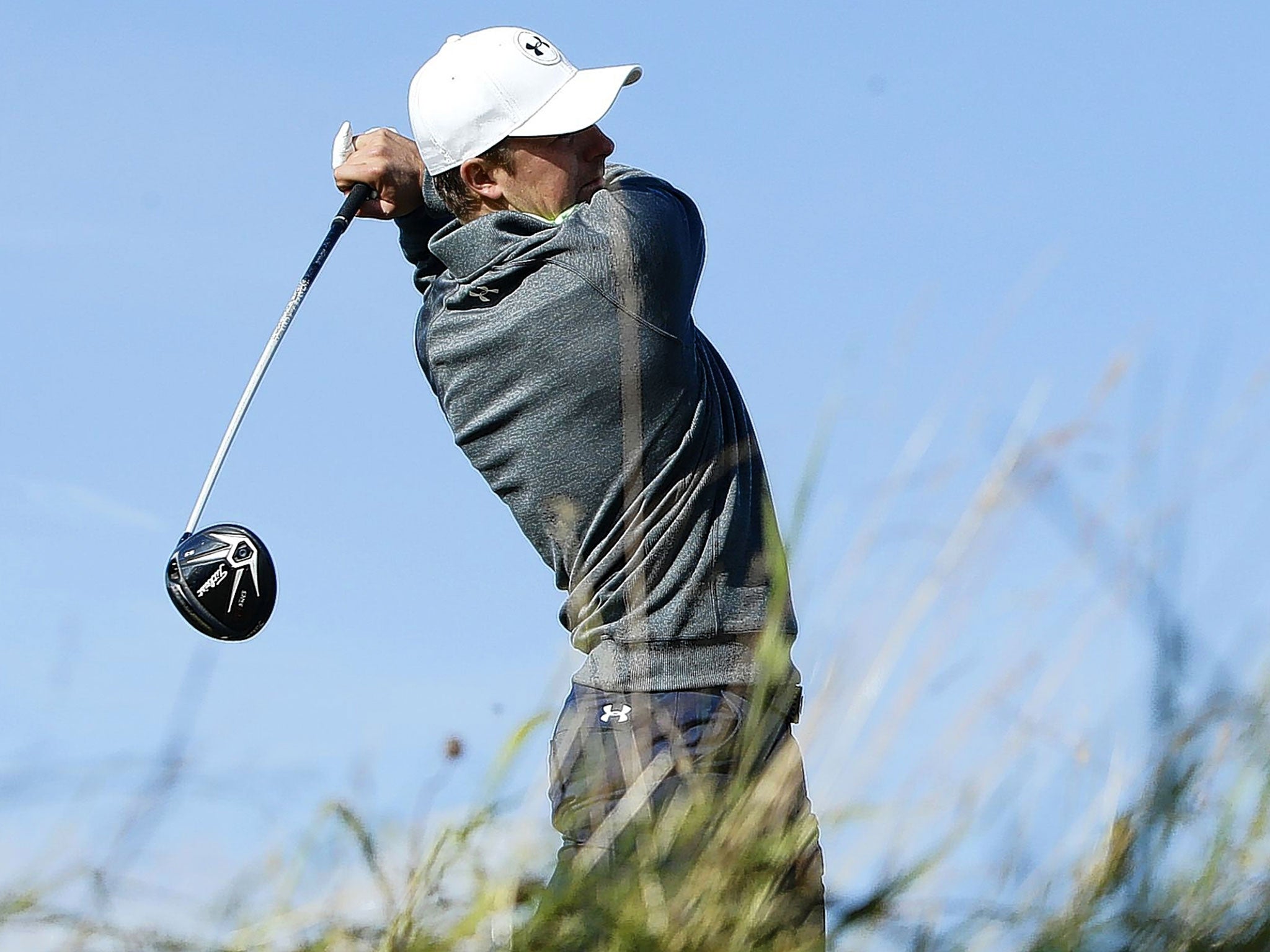 Jordan Spieth hits into the teeth of the wind at the 15th