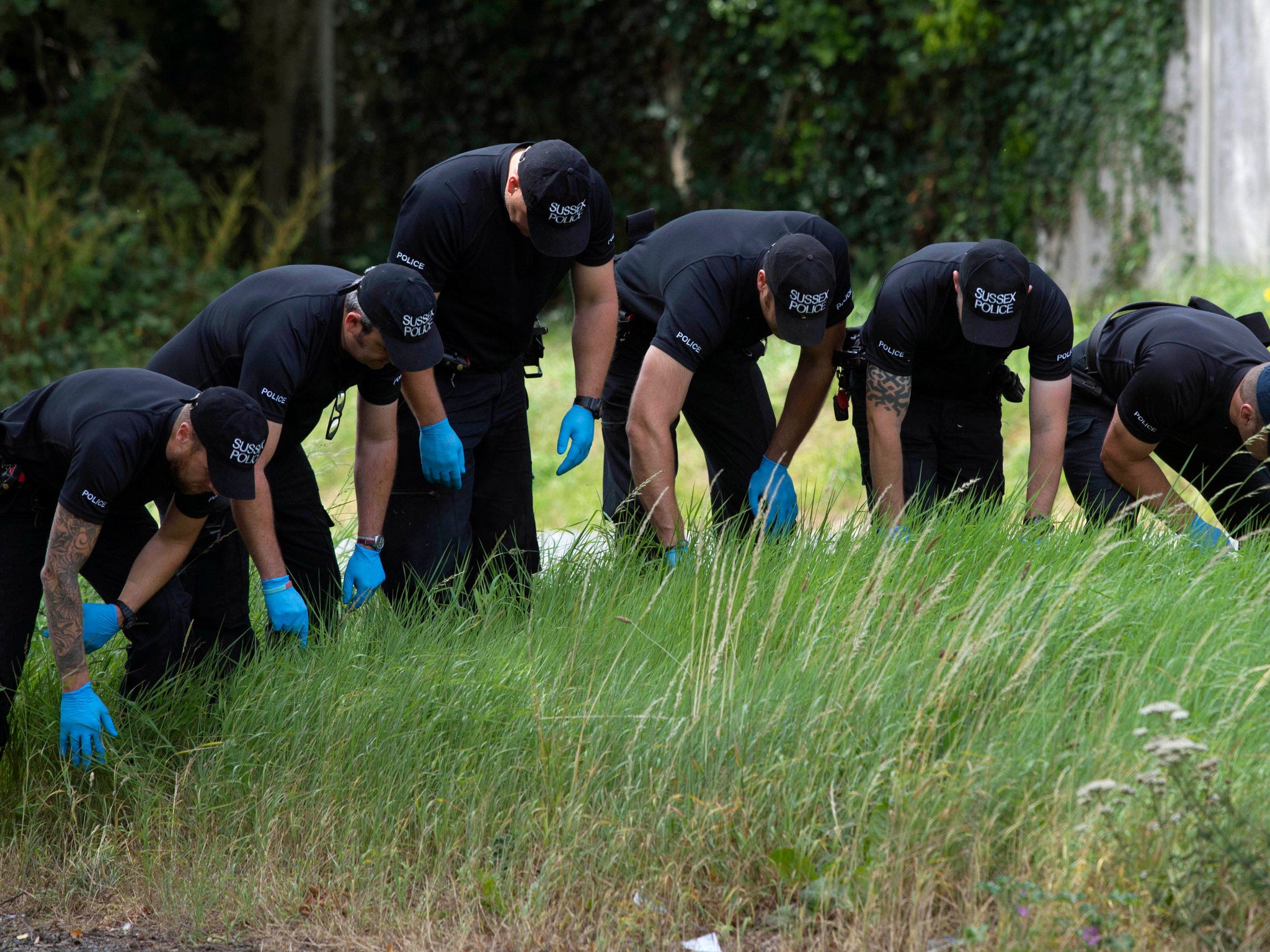 Police search the scene close to where Don Lock was stabbed