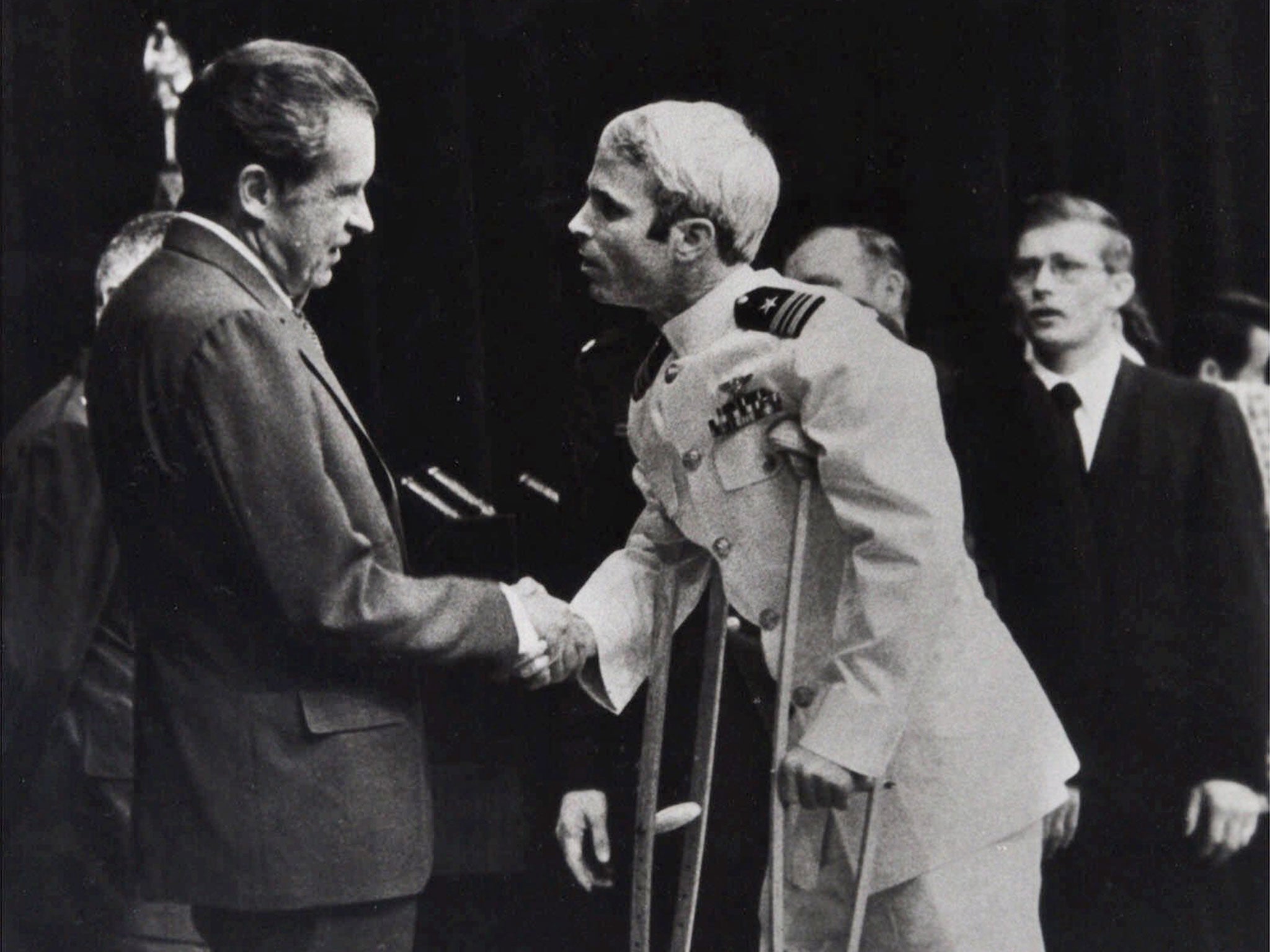 In this Sept. 14, 1973 photo, John McCain, right, is greeted by President Richard Nixon in Washington