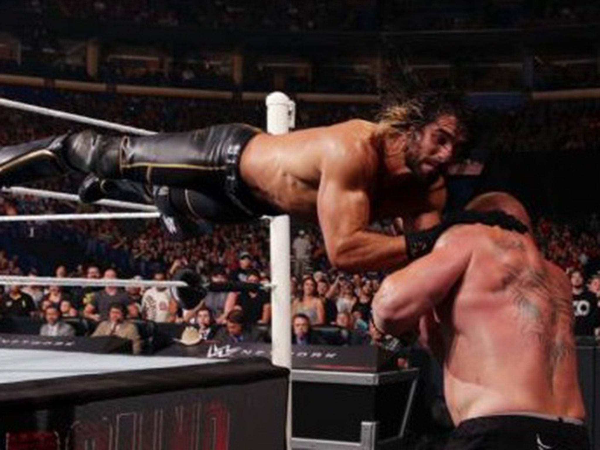 Seth Rollins' dive connects with Brock Lesnar