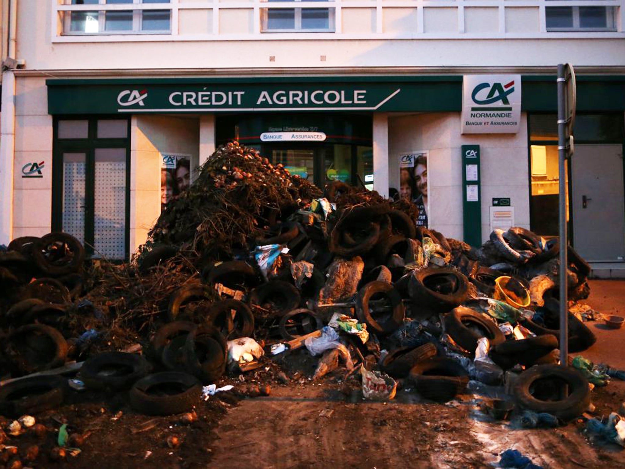 A pile of waste dumped in front of a bank in Caen. Farmers are protesting against the high market prices in supermarkets