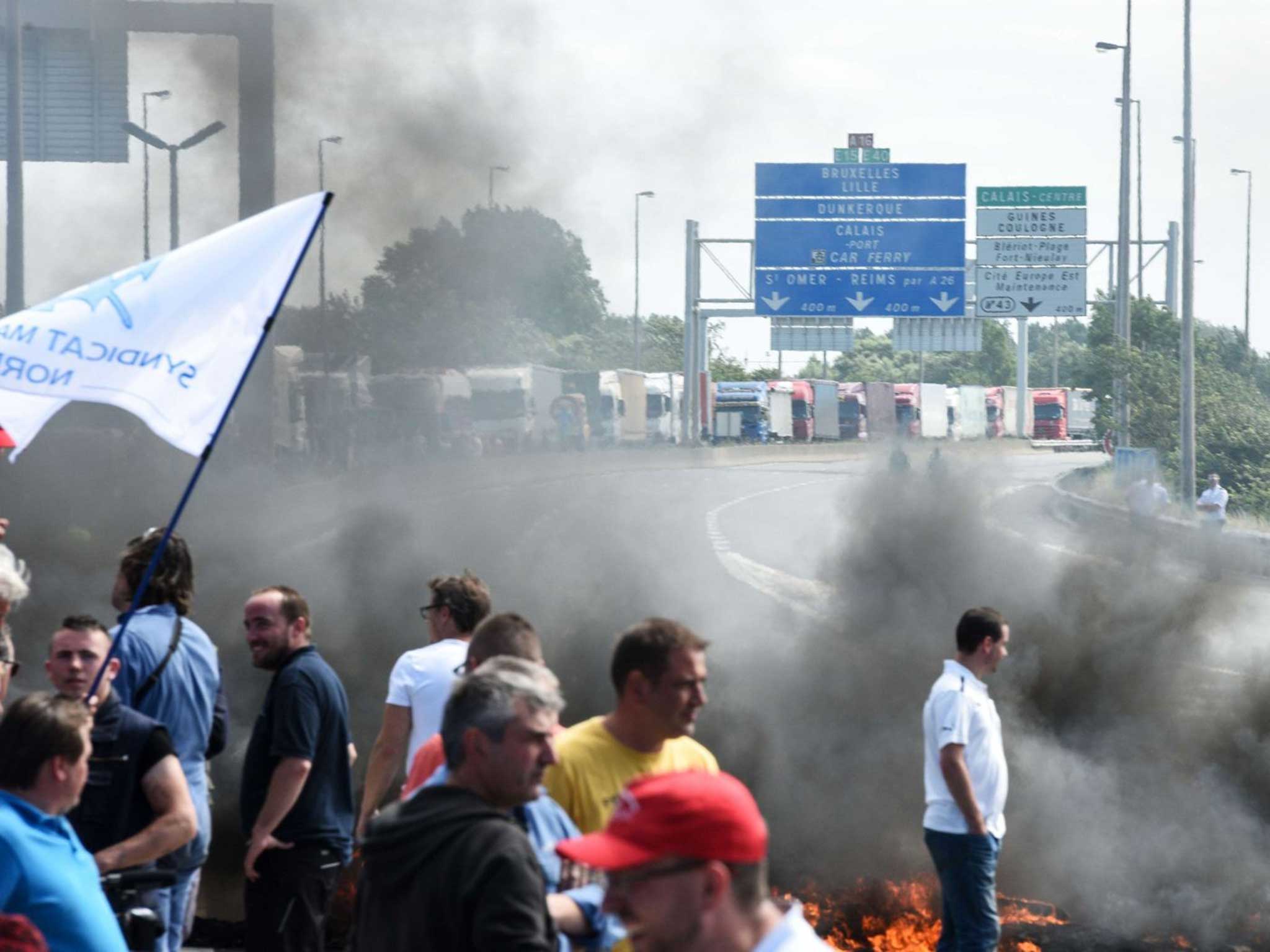 Workers block the road with burning tyres over possible job cuts