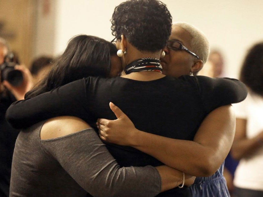 Geneva Reed-Veal, center, hugs family members at a memorial service for her daughter Sandra Bland at Prairie View A&amp;M Universit