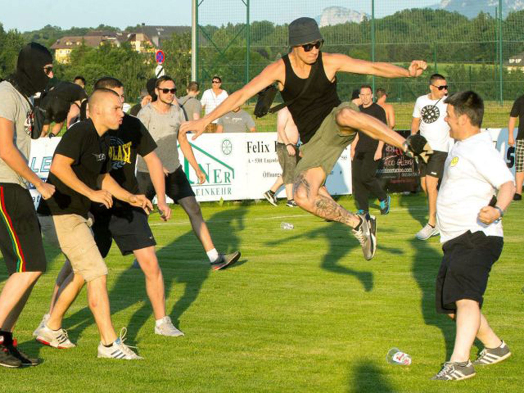 An Eintracht Frankfurt supporter kicks a Leeds fan