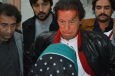 Peshawar school attack: Imran Khan visits families of those killed in Pakistan shooting to say Eid-ul-Fitr prayers at the end of Ramadan