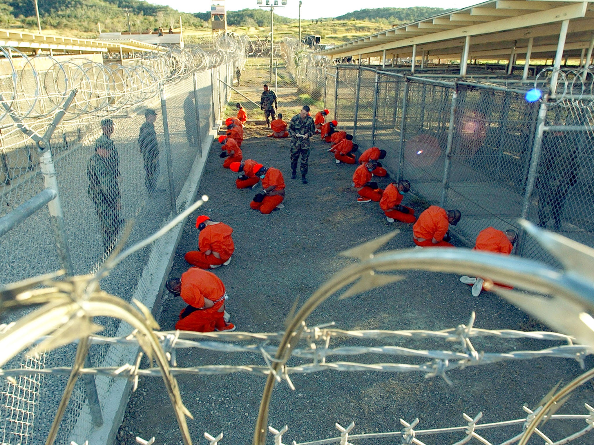 "Shaker Aamer’s long-overdue return to Britain brings one long, painful chapter to a close. Although for 113 other detainees the Guantánamo nightmare is still far from over" Photograph: Guantanamo Bay, 11 January 2002