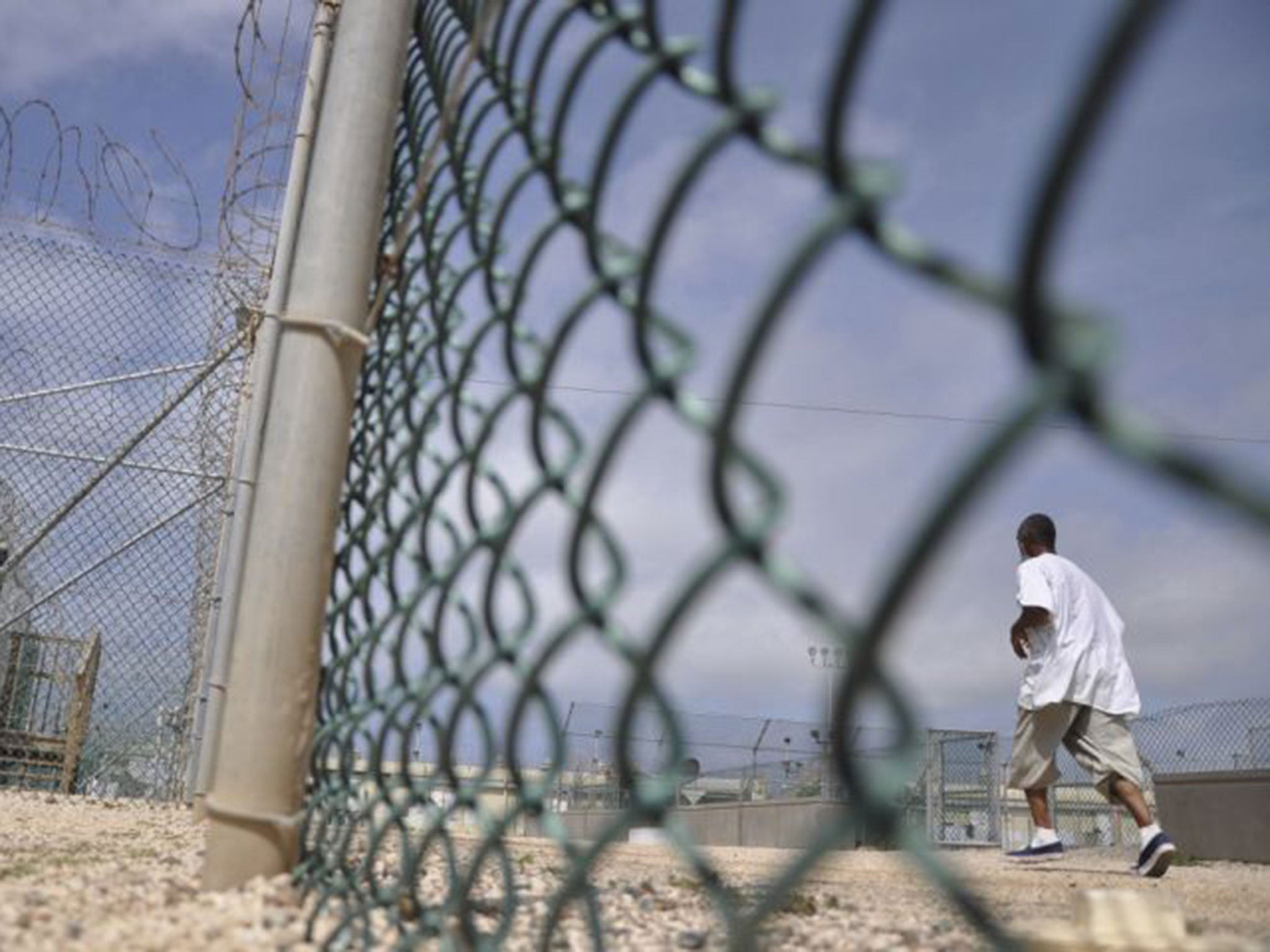 A Guantanamo detainee runs inside an exercise area at the detention facility April 27, 2010