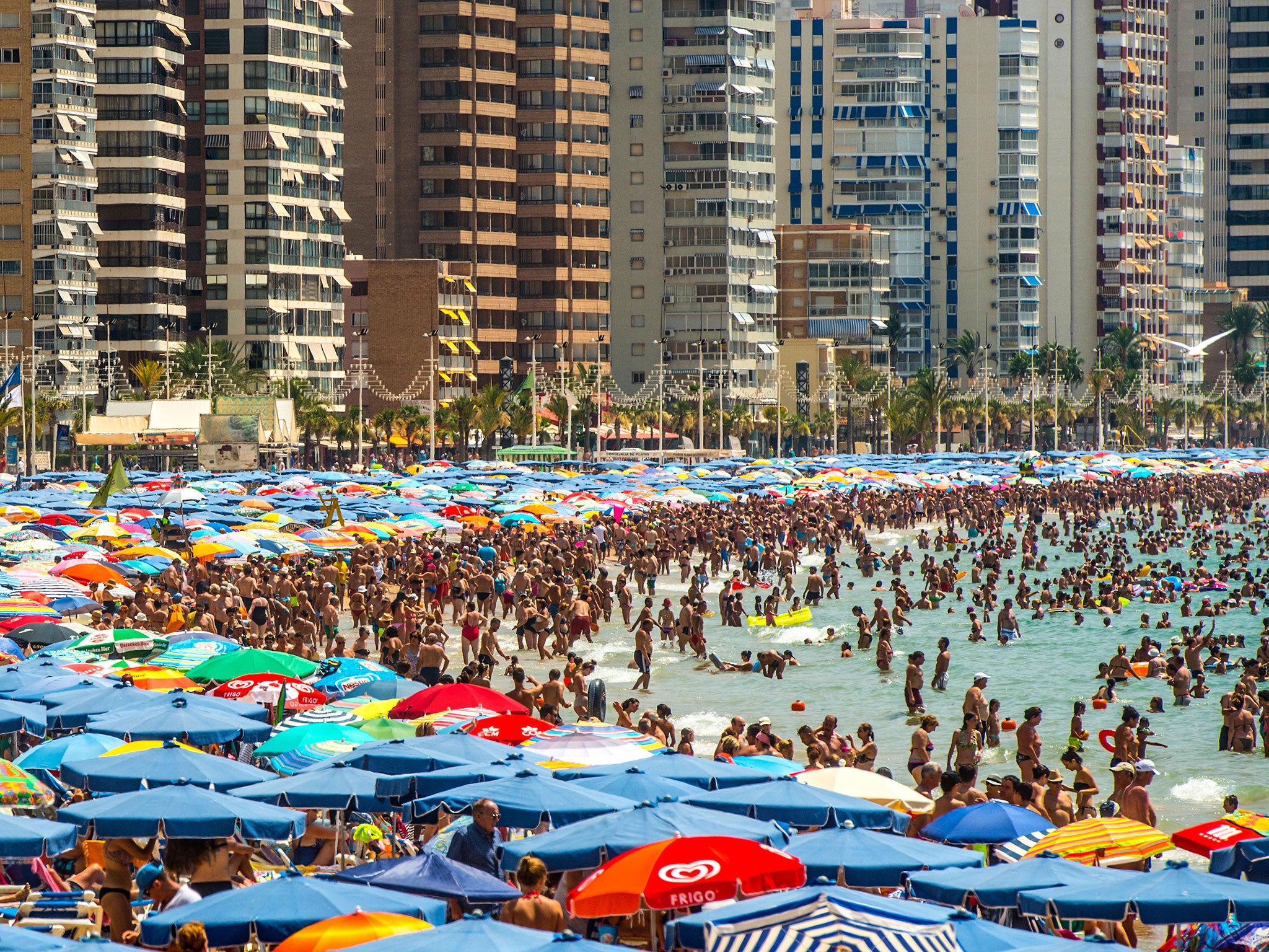 People sunbathe at Levante Beach on July 22, 2015 in Benidorm, Spain