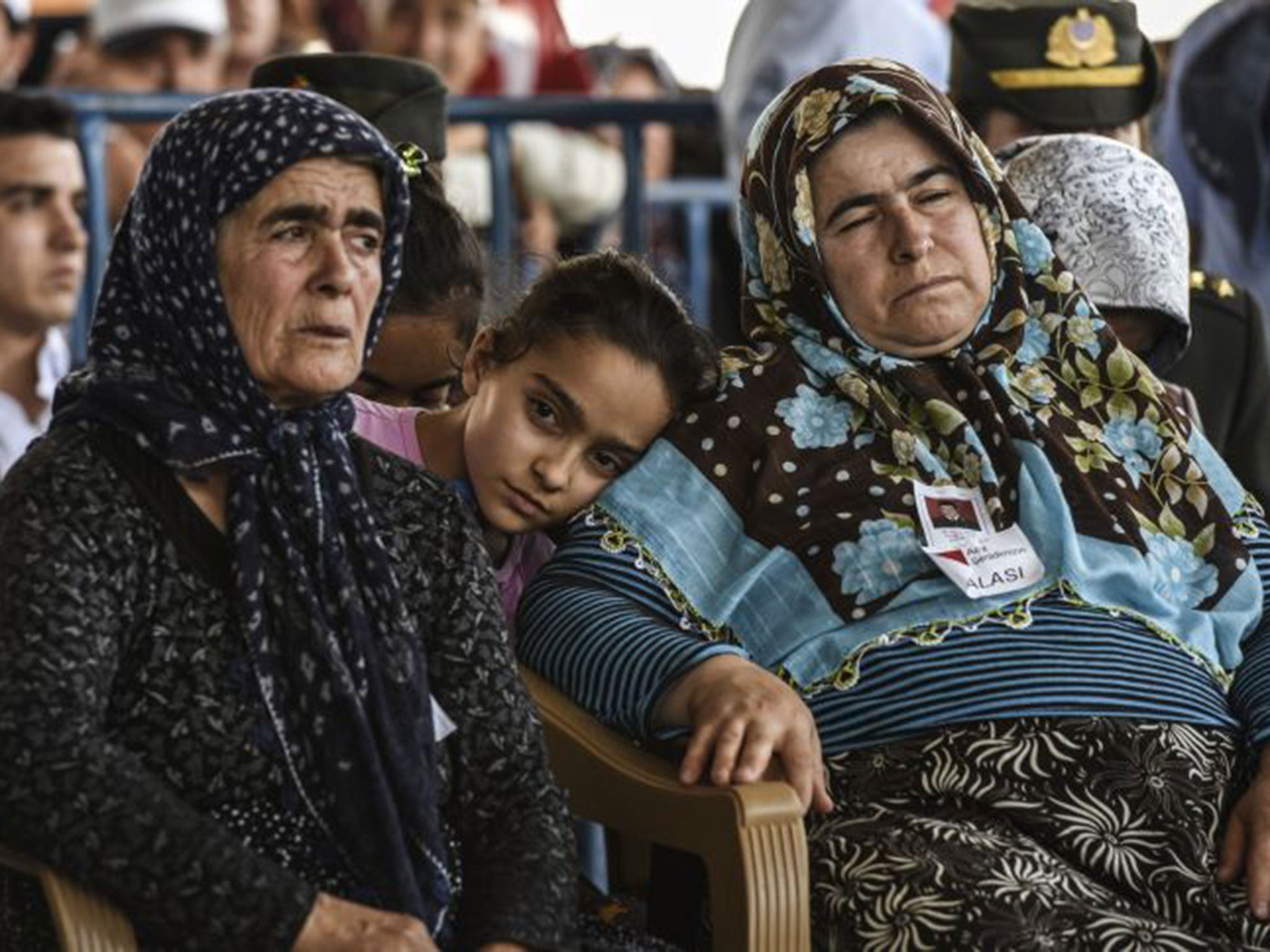 Relatives mourn during the burial ceremony for Turkish soldier Mehmet Yavuz Nane on July 24, 2015 in Gaziantep