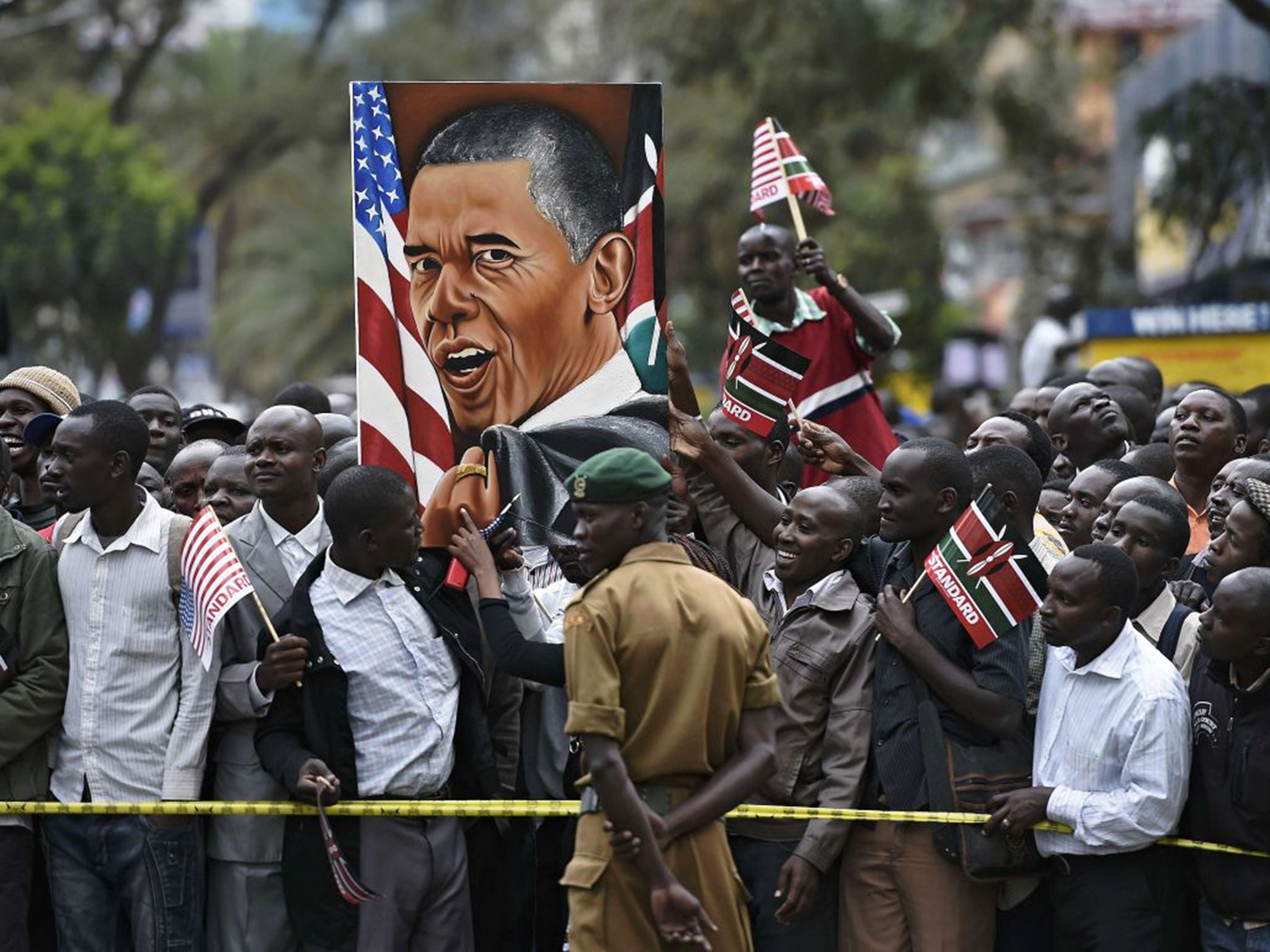 Crowds gather to watch the motorcade in Nairobi