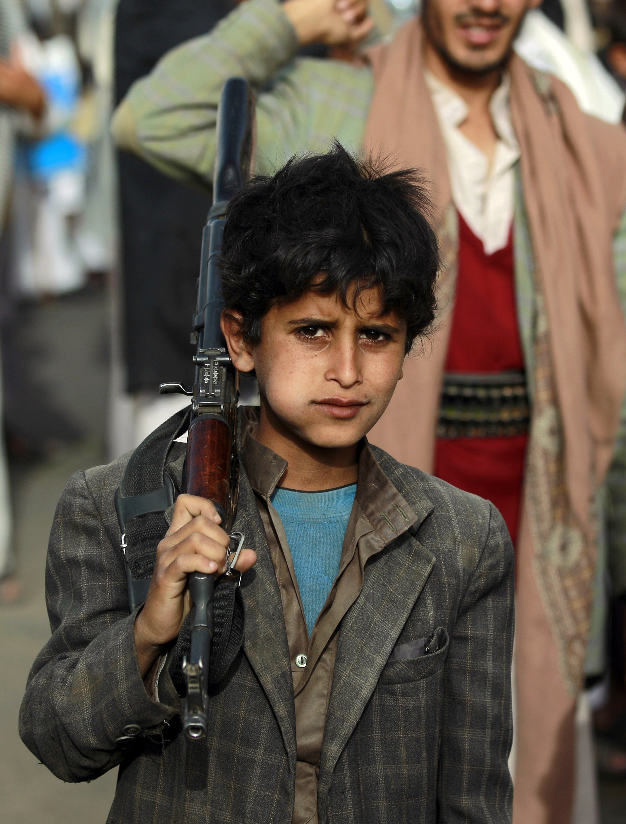 A young boy marches in a pro-Houthi march in the Yemeni capital of Sanaa in May 2015